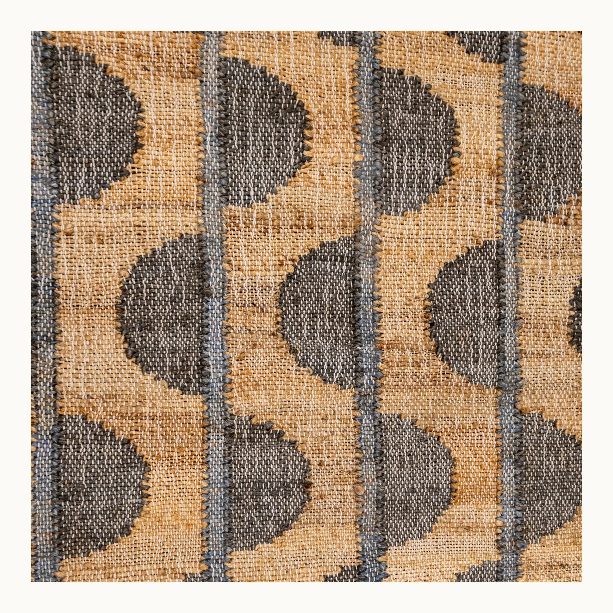 Handwoven jute rug with repeating half-moon pattern in olive green and natural sand tones.