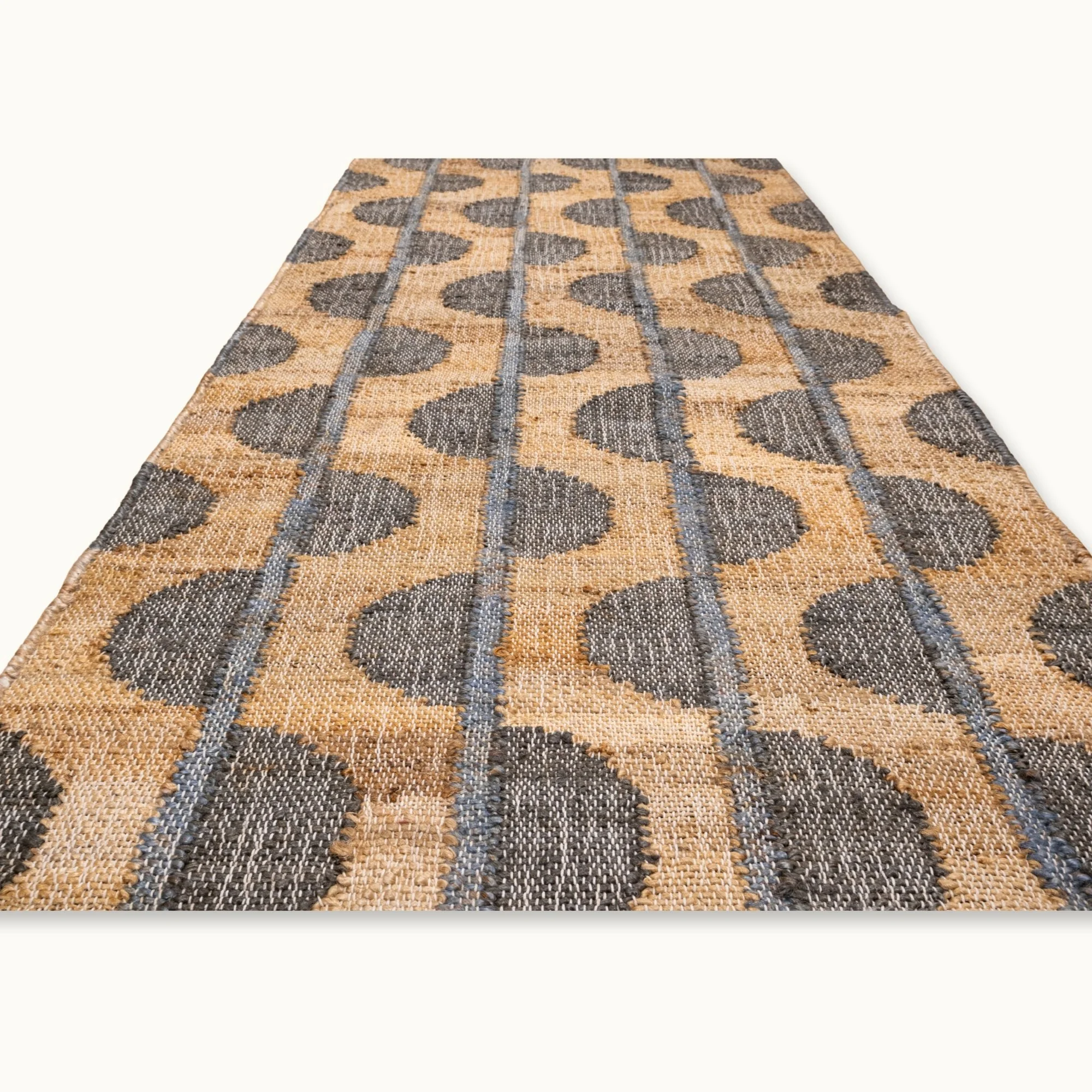 Handwoven jute rug with repeating half-moon pattern in olive green and natural sand tones.