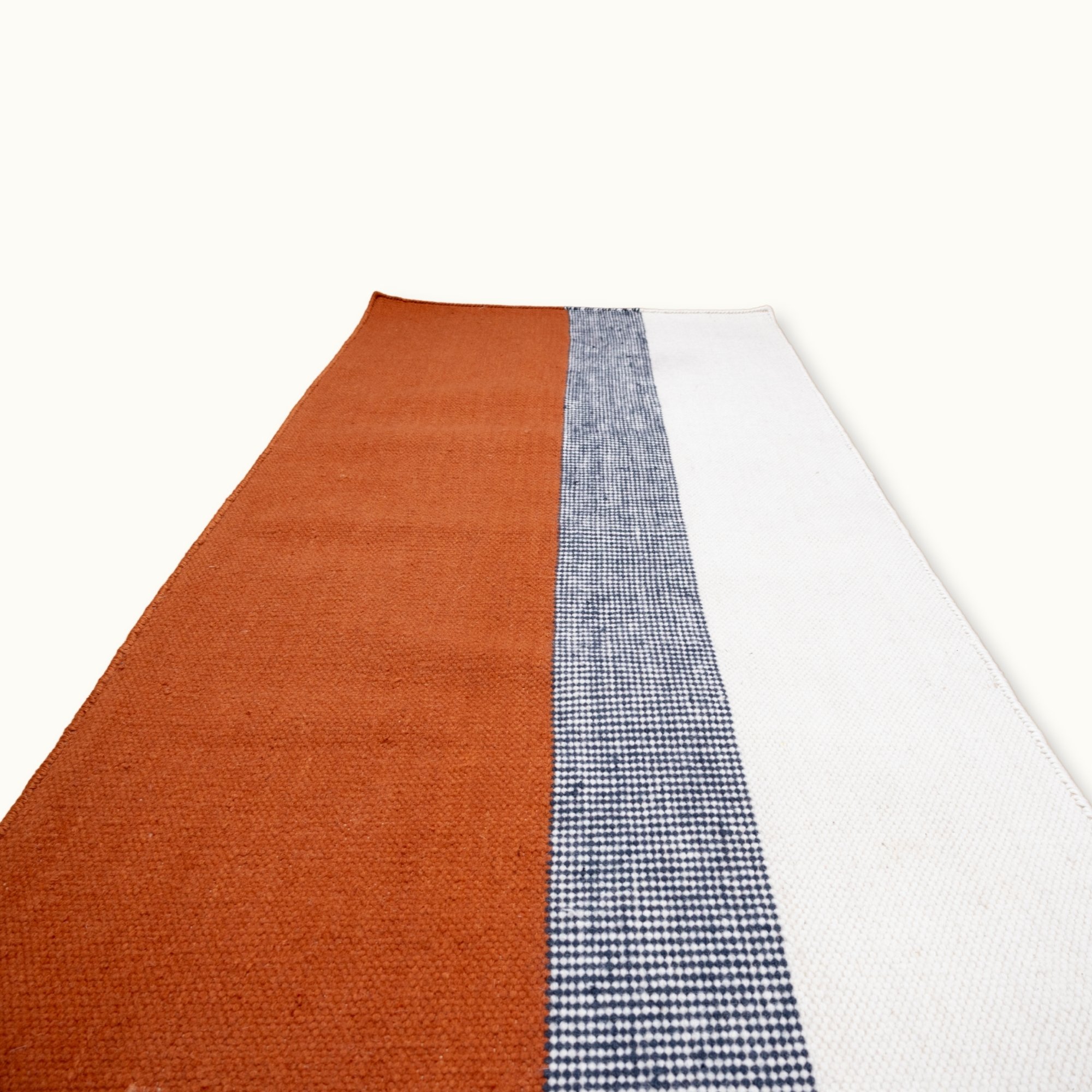 Handwoven striped runner rug in brown, blue and ivory with a modern flatweave design.