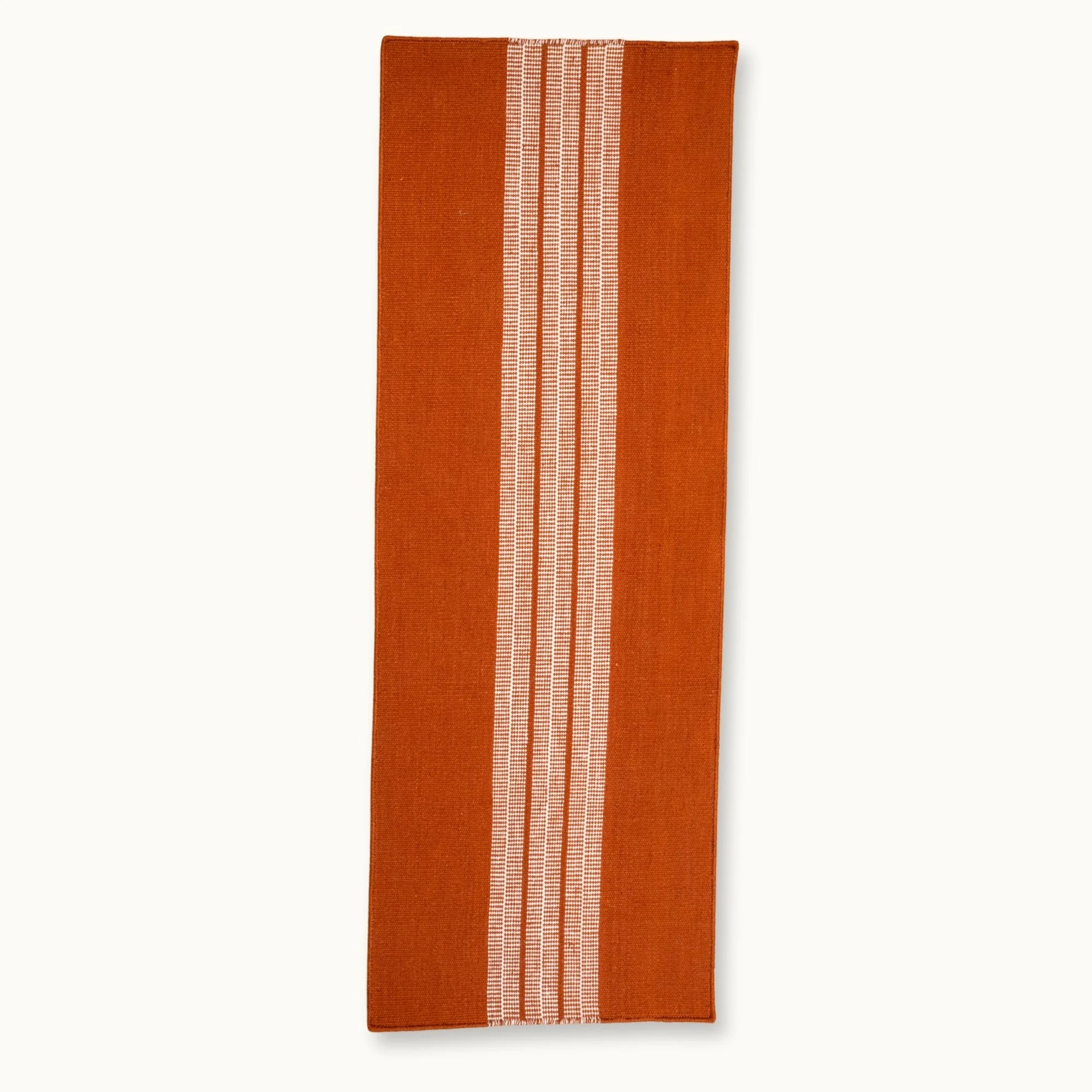 Handwoven striped runner rug in brown and ivory with a modern flatweave design.