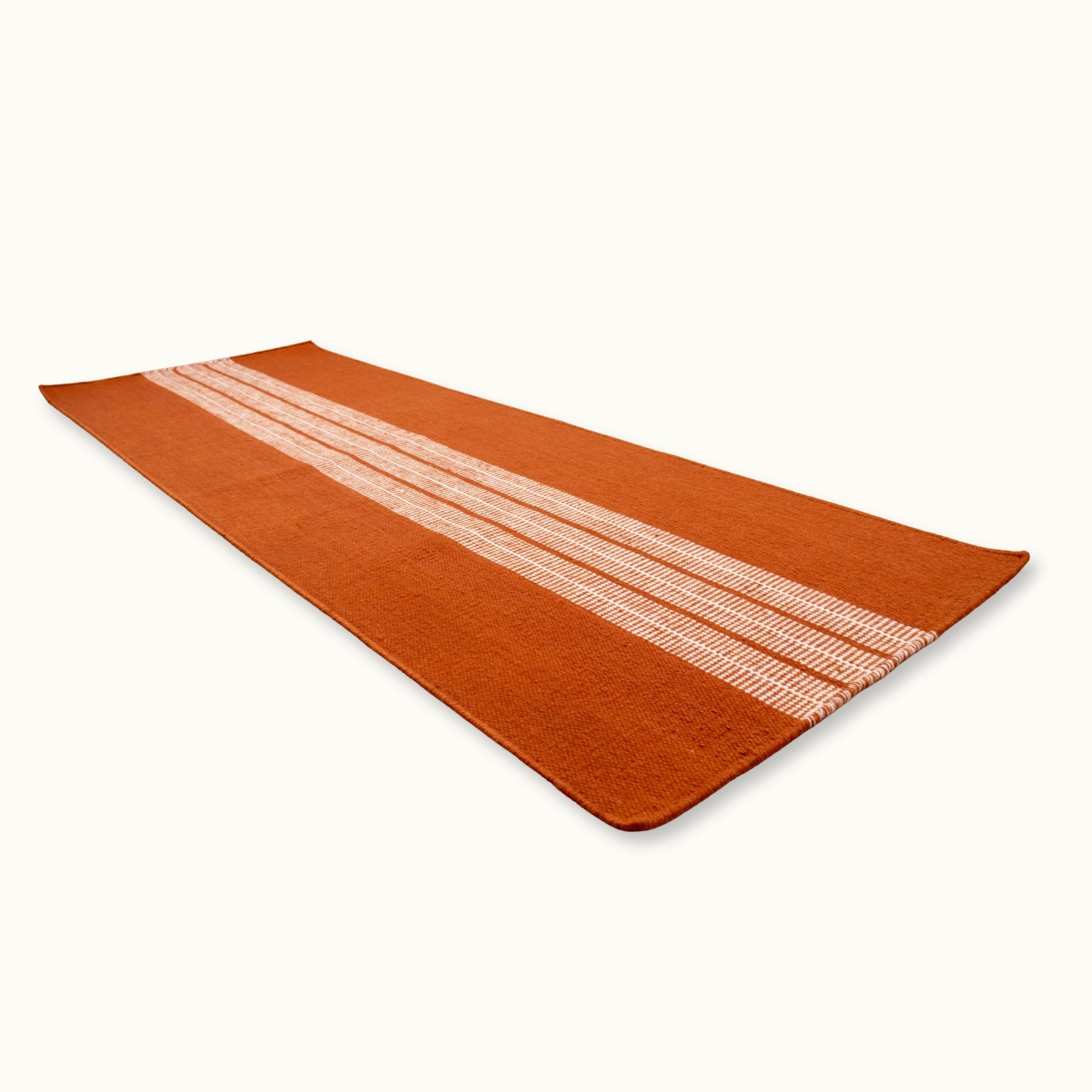 Handwoven striped runner rug in brown and ivory with a modern flatweave design.