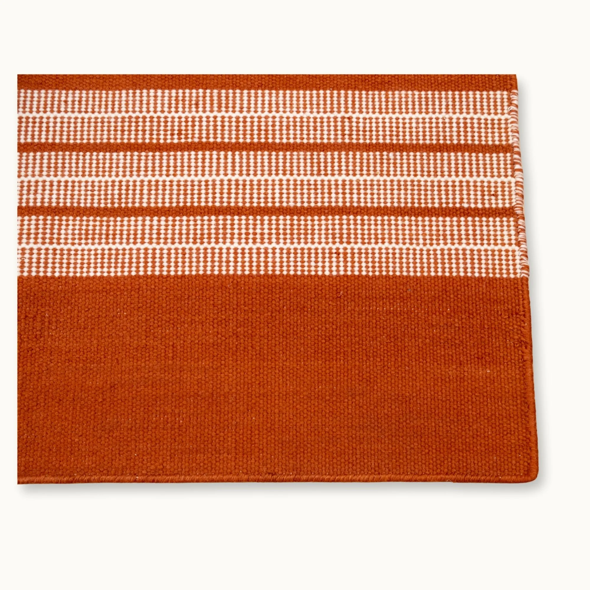 Handwoven striped runner rug in brown and ivory with a modern flatweave design.