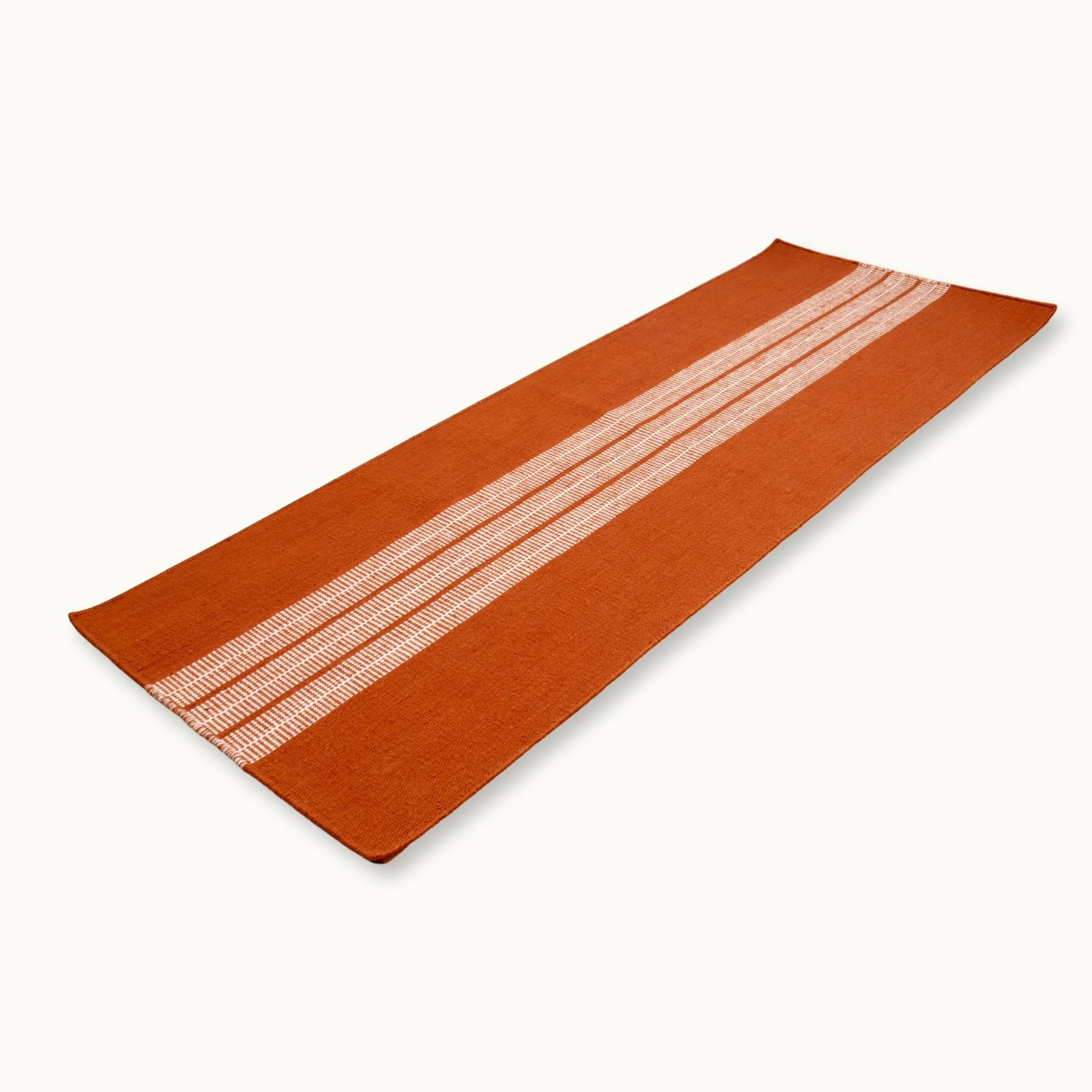 Handwoven striped runner rug in brown and ivory with a modern flatweave design.