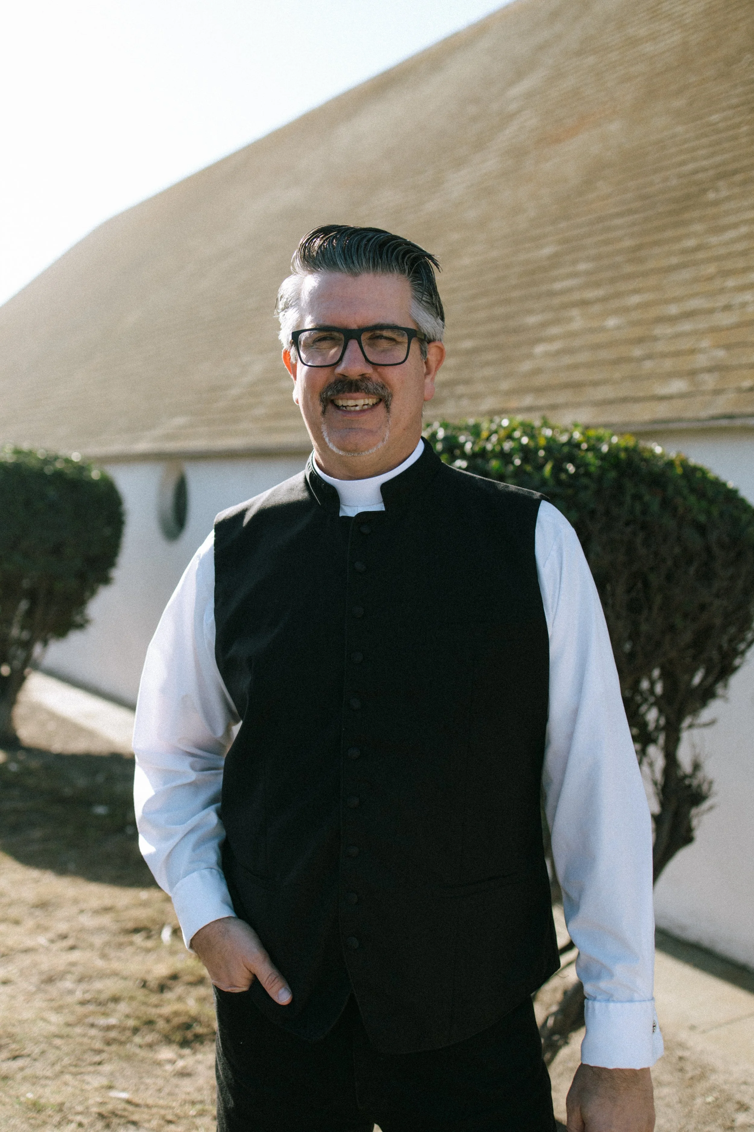Rev. Dr. Daniel R. Hyde in front of the chapel of the OURC