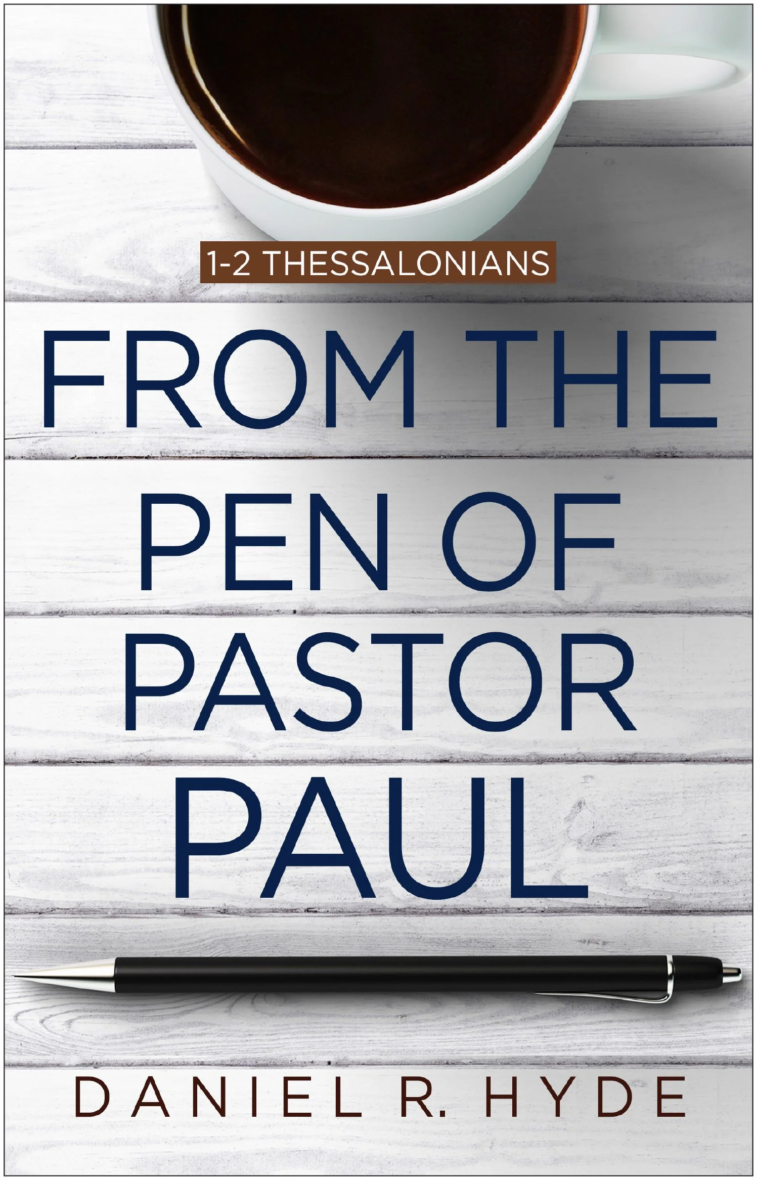 Book cover titled '1-2 Thessalonians from the Pen of Pastor Paul' by Daniel R. Hyde, featuring a white wooden background, a black pen at the bottom, and a cup of coffee at the top.