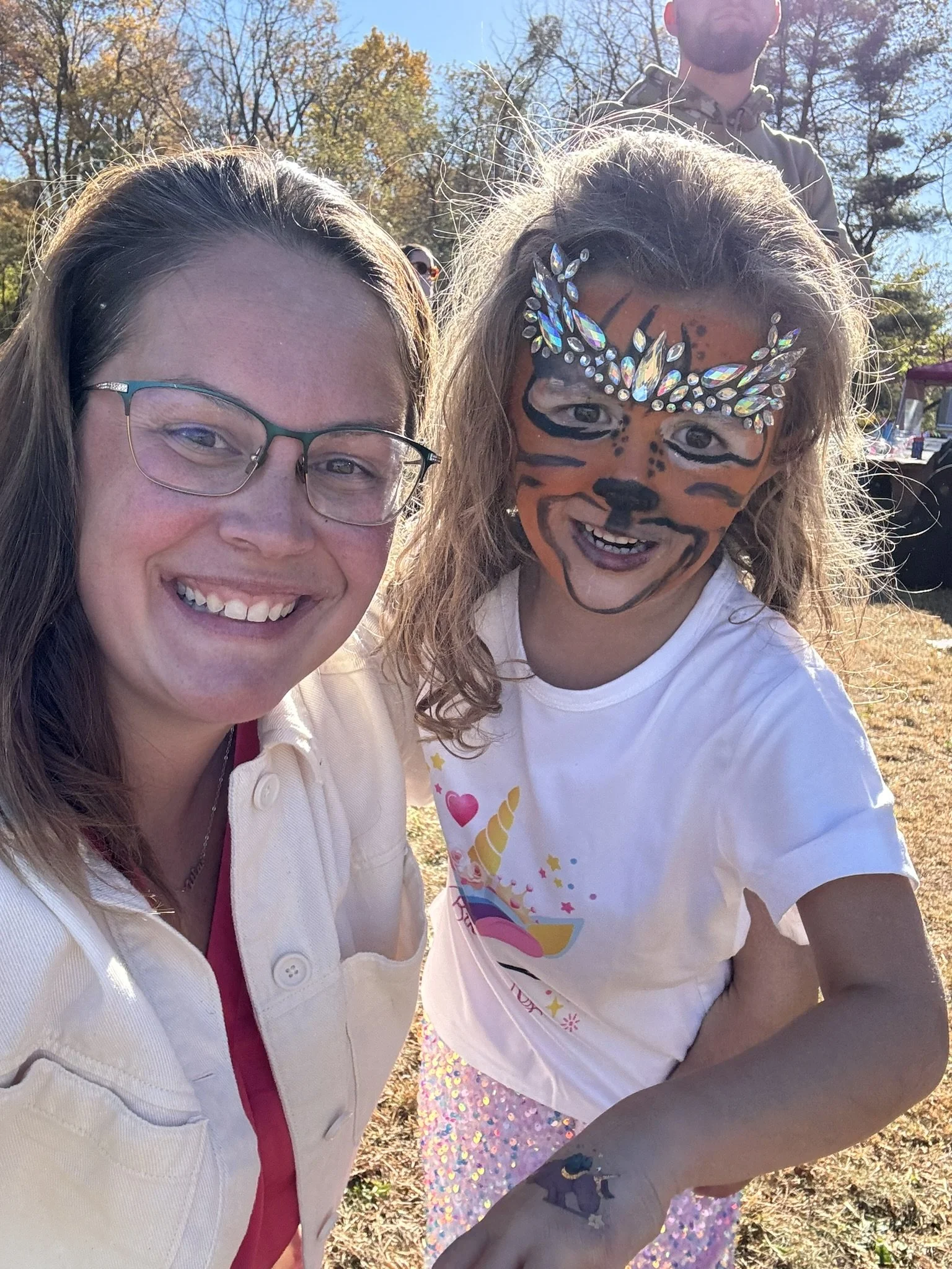 Mother and daughter celebrating fifth birthday party with tiger face paint and face jewels on Stargazer Fields Farm Millstone Township NJ - CelebrationShare