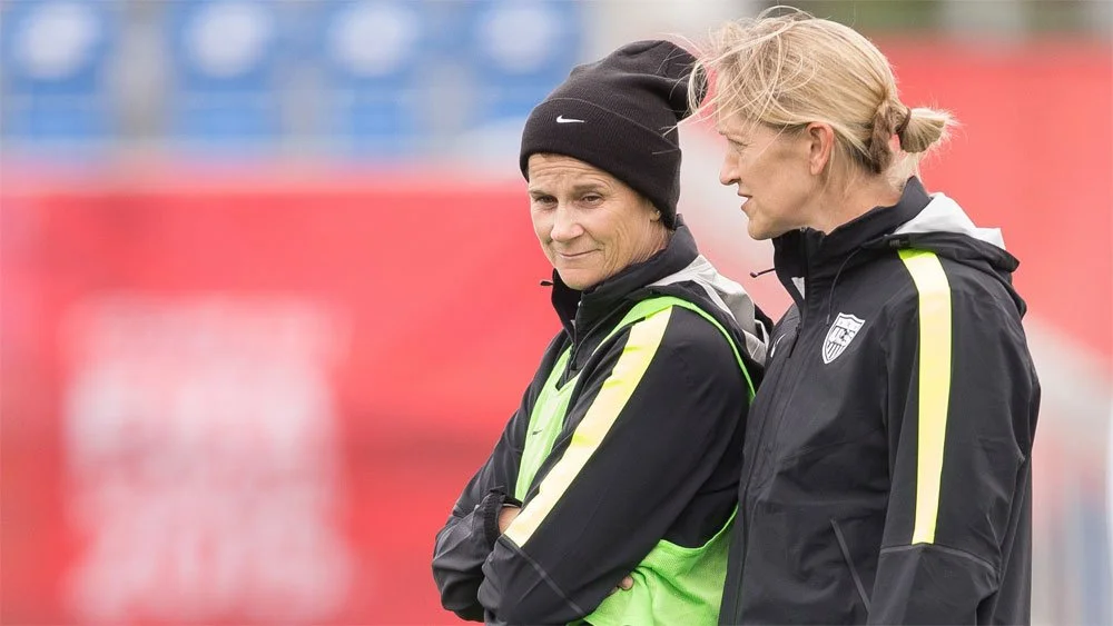 Dawn Scott talking outdoors on a sports field.