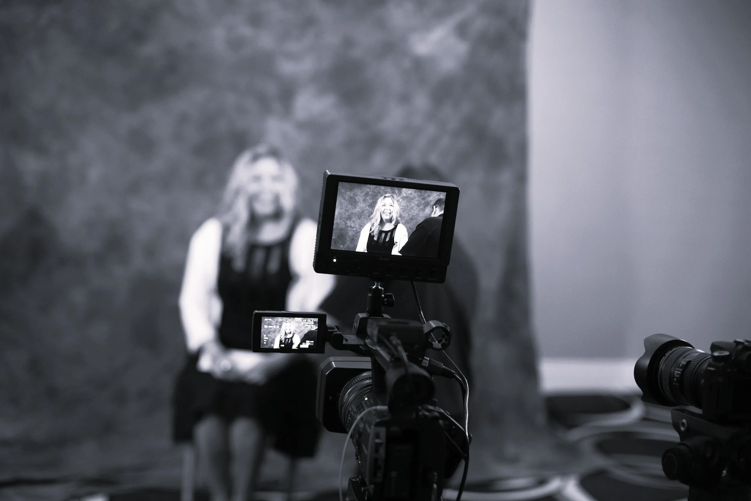 A woman with wavy hair, Andi Campbell, being interviewed on video in Hartford, CT