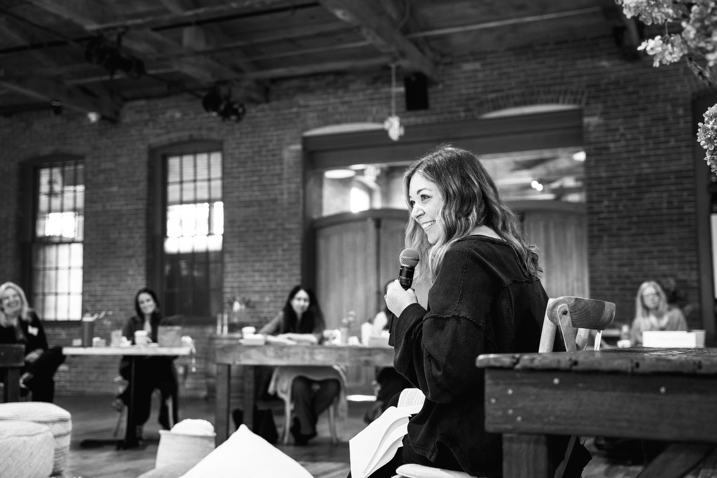 Andi Campbell speaking at an event.