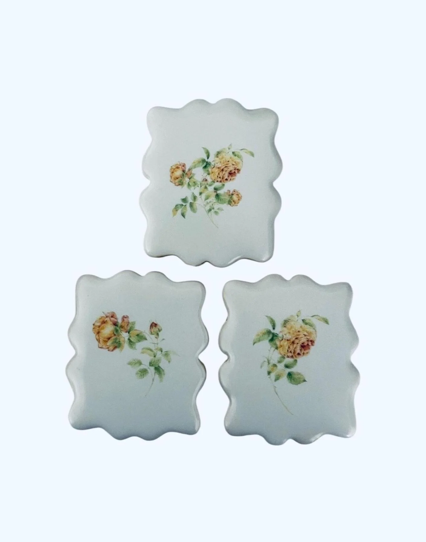 Vintage botanical rose cookies arranged as a set on scalloped square sugar cookies