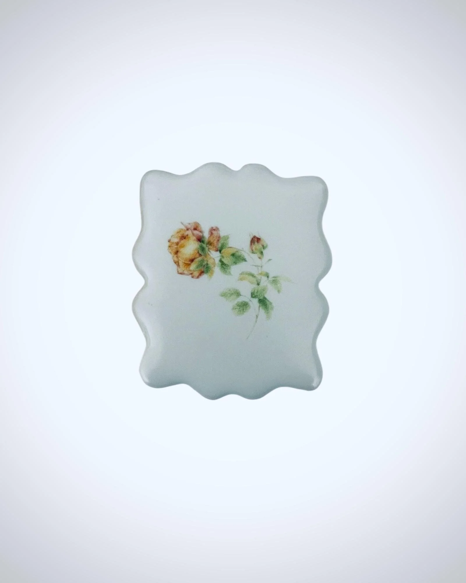 Close-up of floral sugar cookie with delicate rose artwork