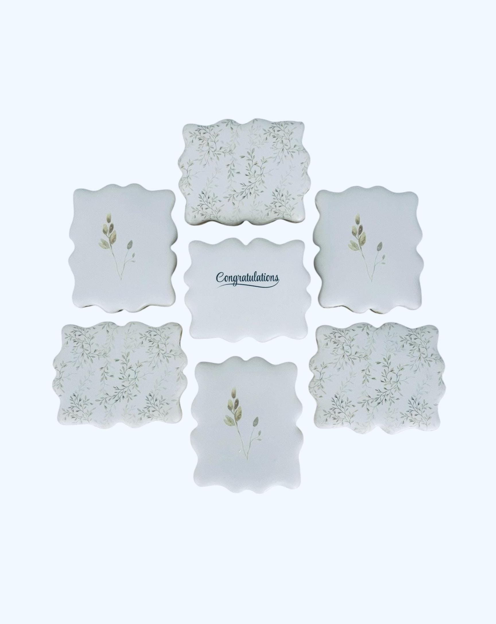 congratulations cookie set with neutral botanical designs arranged in a grid
