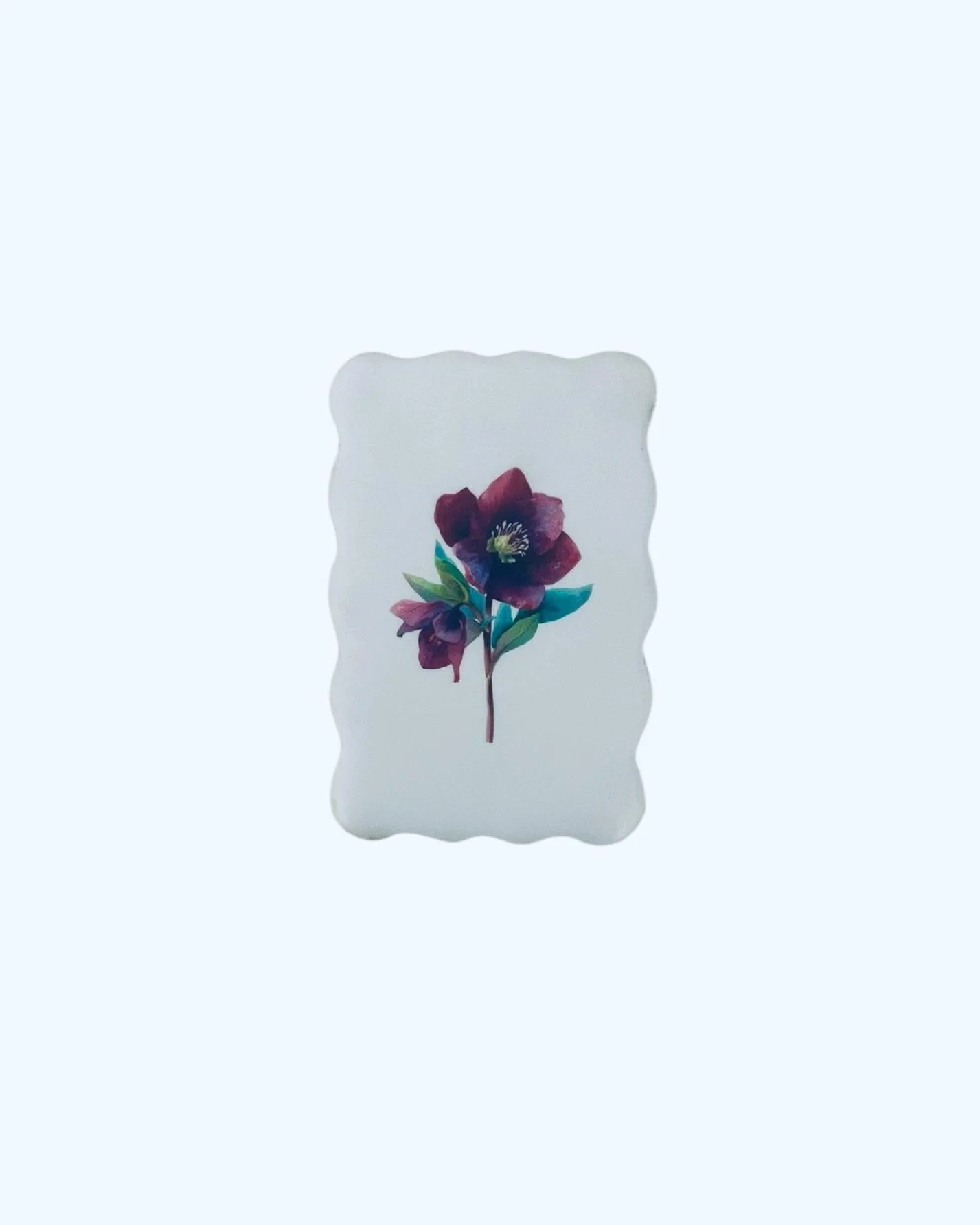 Single floral cookie with minimal botanical illustration on white icing