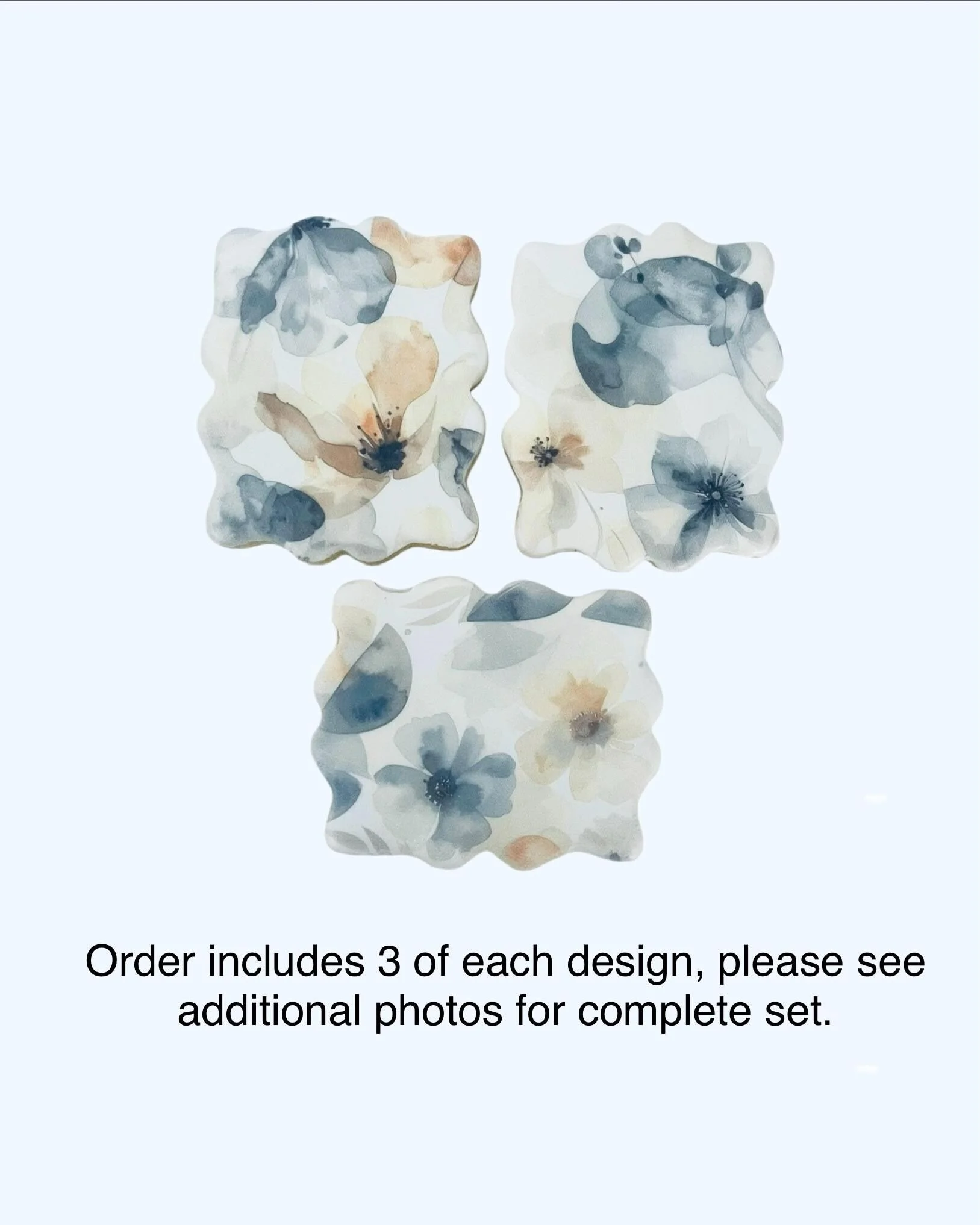 Three floral cookies with soft muted tones on white icing