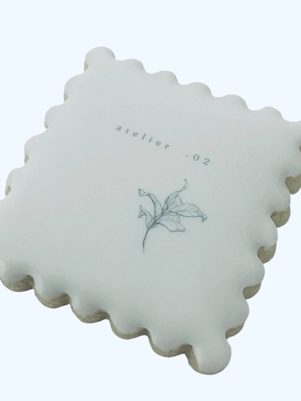 single scalloped logo cookie printed with corporate branding on royal icing