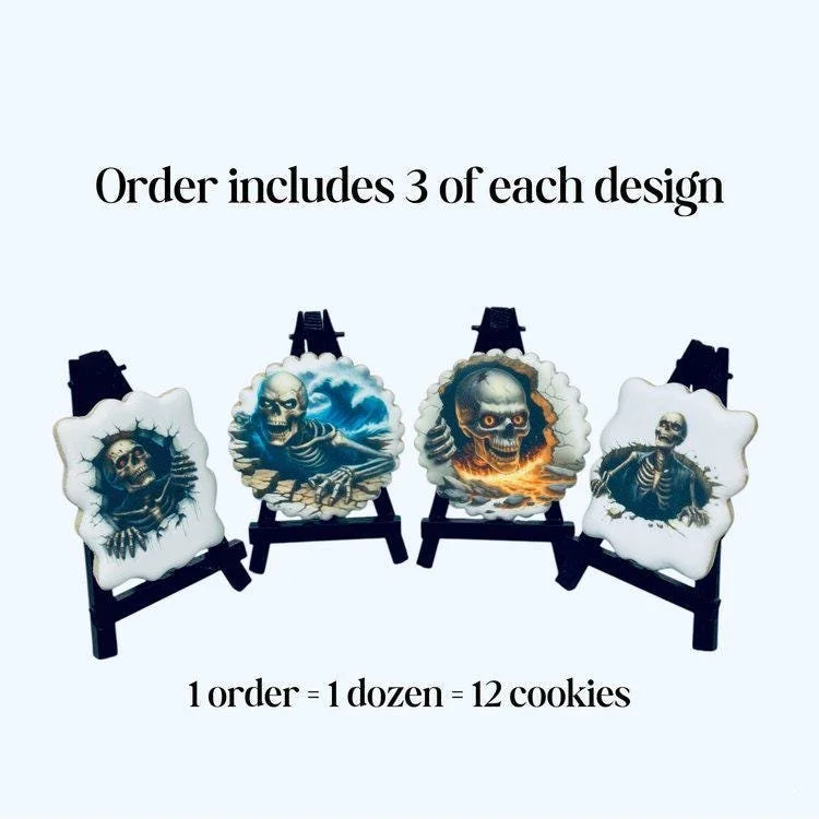 Halloween skeleton cookies with detailed skull designs on white icing