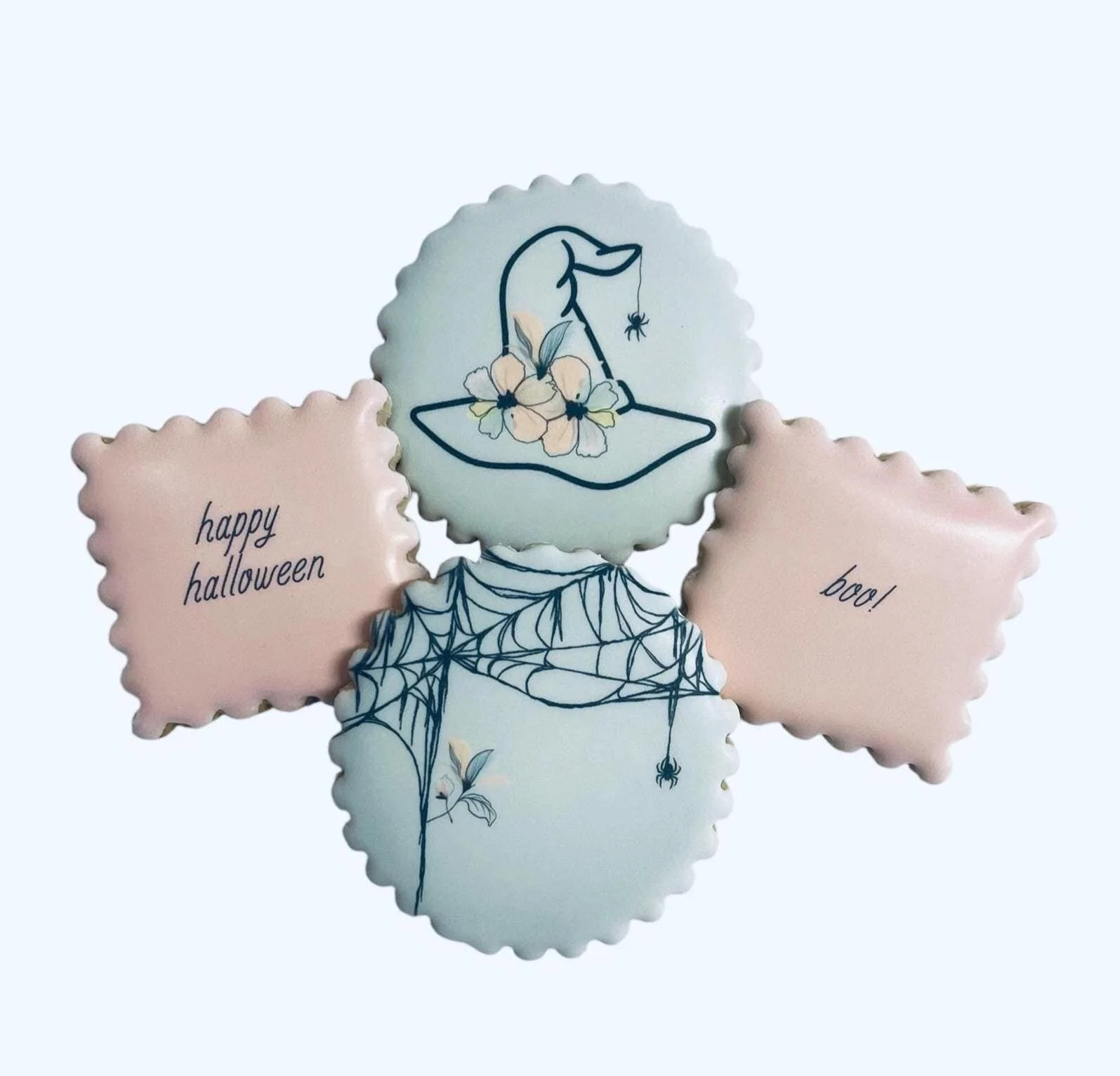 Pastel Halloween cookies with soft spooky designs on white icing