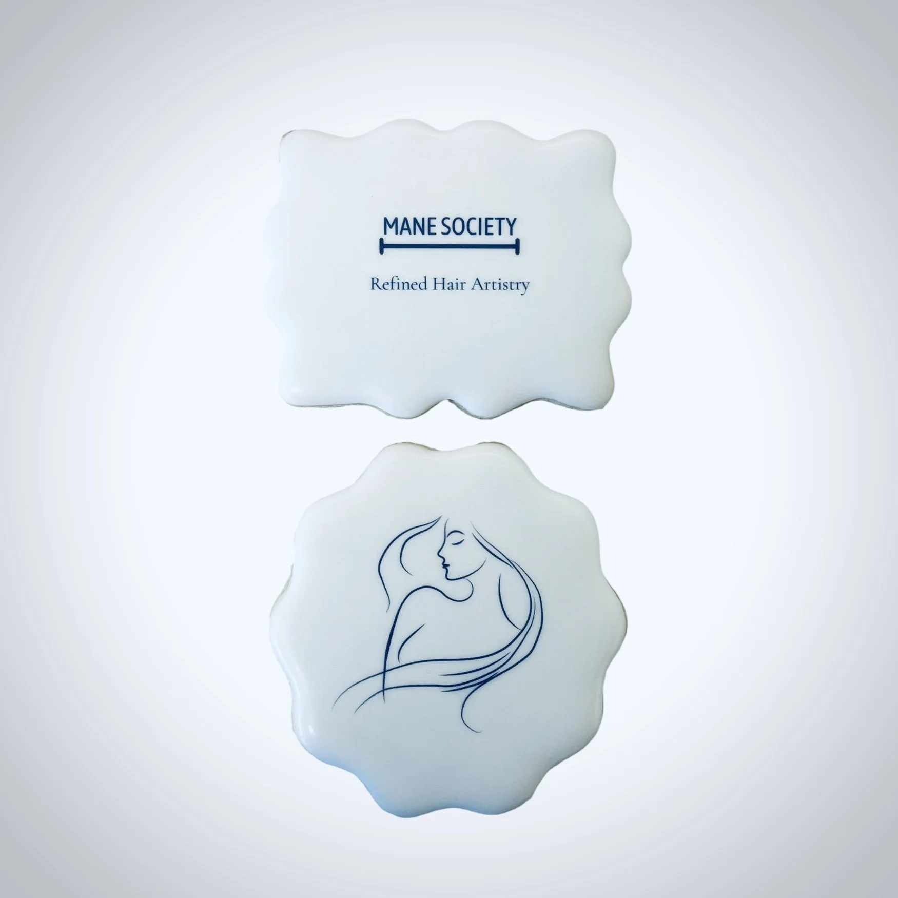 Custom printed cookies for hair salon branding featuring minimalistic female line art and modern logo design on scalloped cookies.