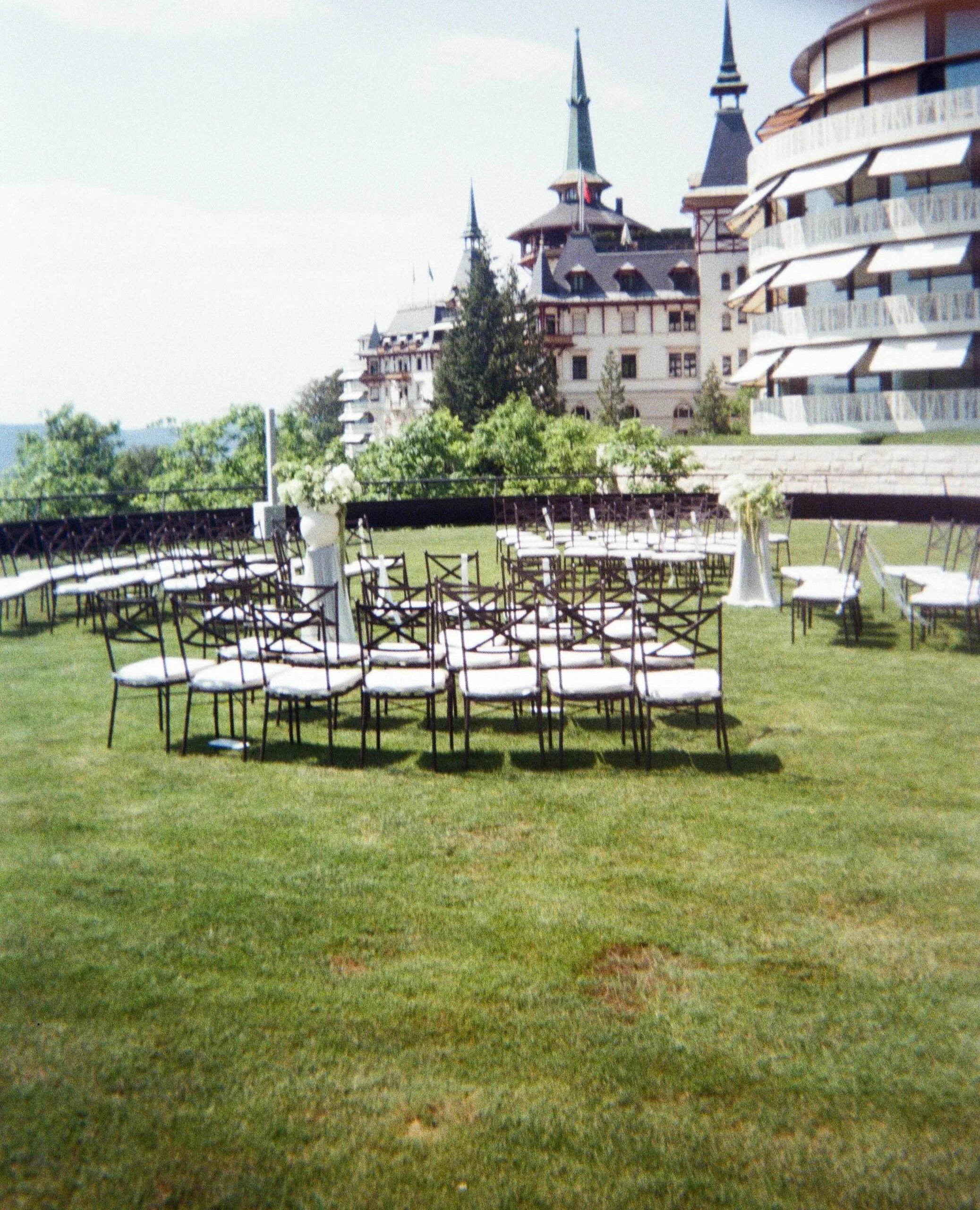 Elegant outdoor wedding ceremony on the lawn at The Dolder Grand, Zurich, Switzerland.