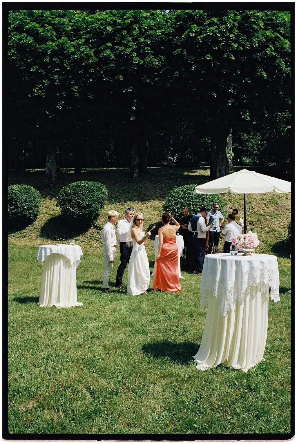 Guests enjoying a relaxed château garden drinks reception with live jazz, rosé stations and lawn games at a Loire Valley destination wedding.