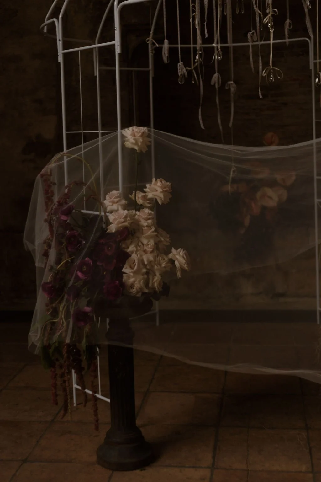 Opulent vintage wedding ceremony under a pergola with urns, florals, and curated bridal fashion details