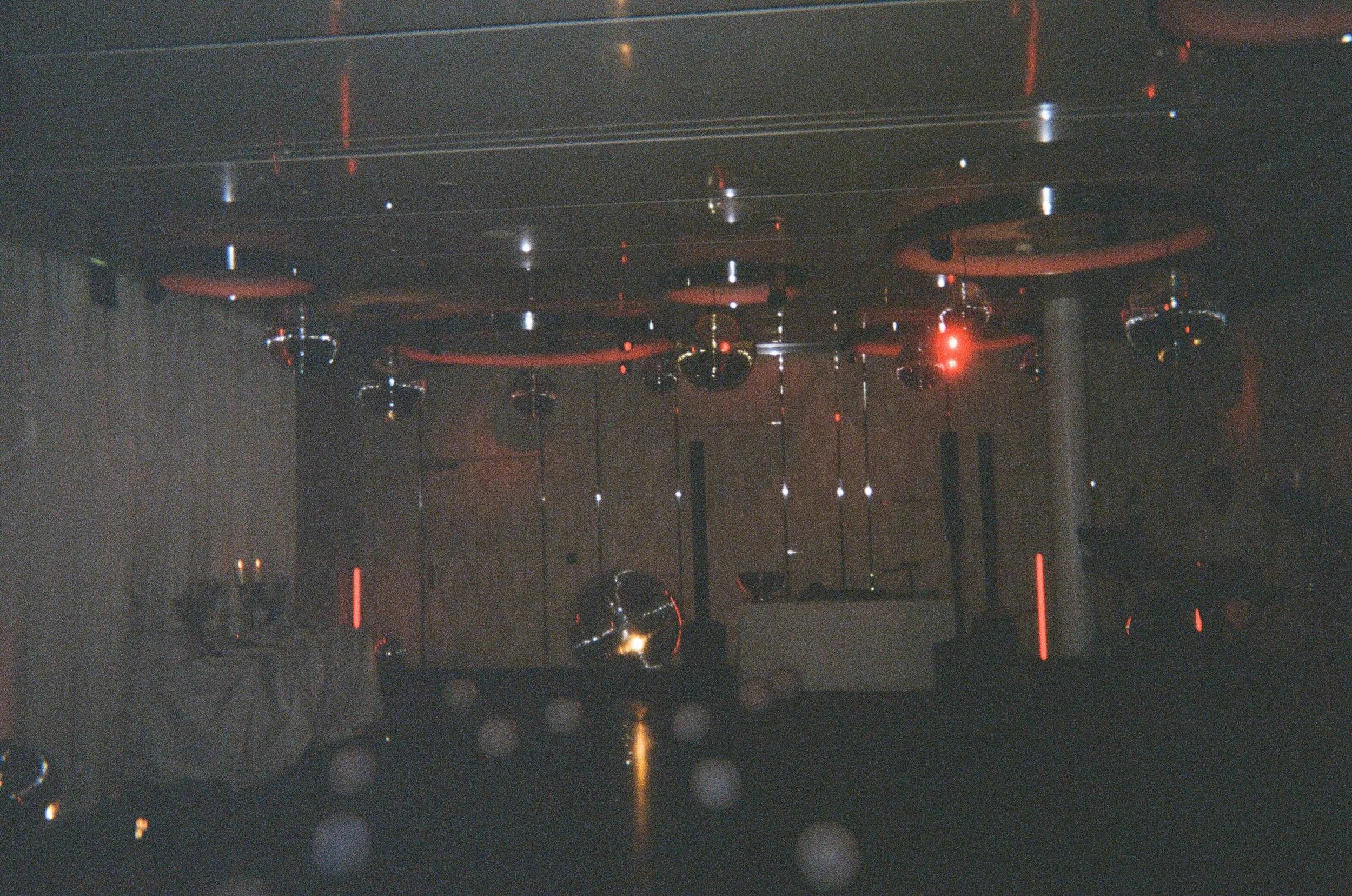 Red lighting design creating a bold nightclub atmosphere at a luxury destination wedding at The Dolder Grand in Zurich, Switzerland.