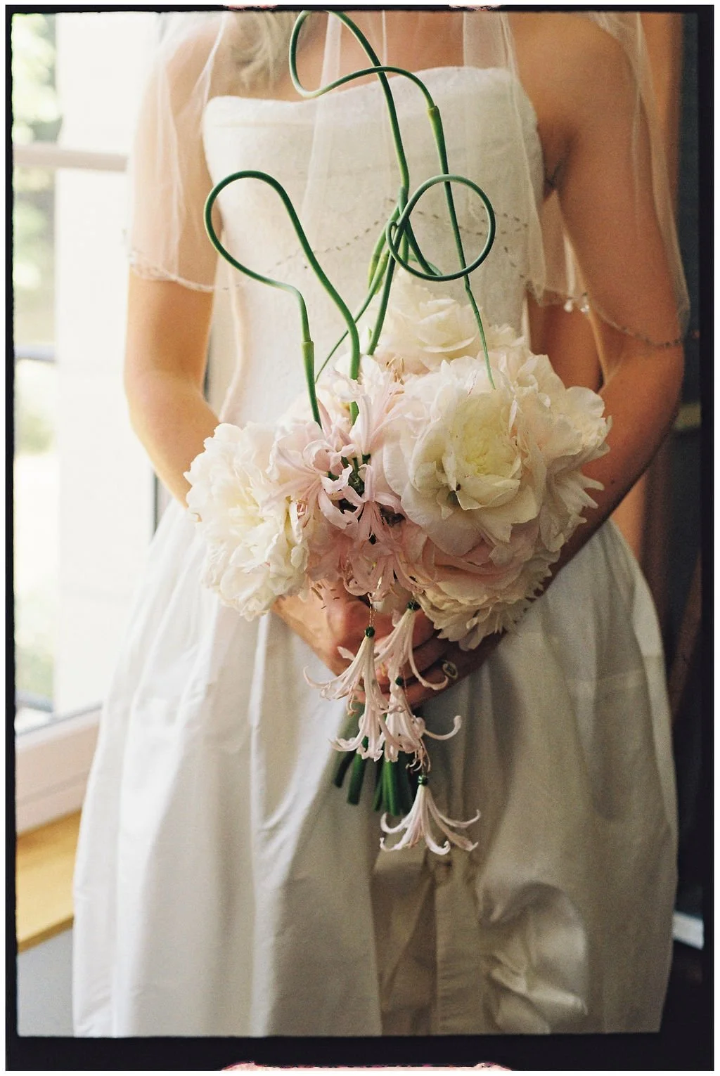 Bride wearing a timeless wedding gown with a peony bouquet by House of Prose and vintage pink Gucci heels at Château Laborde Saint-Martin, Loire Valley.