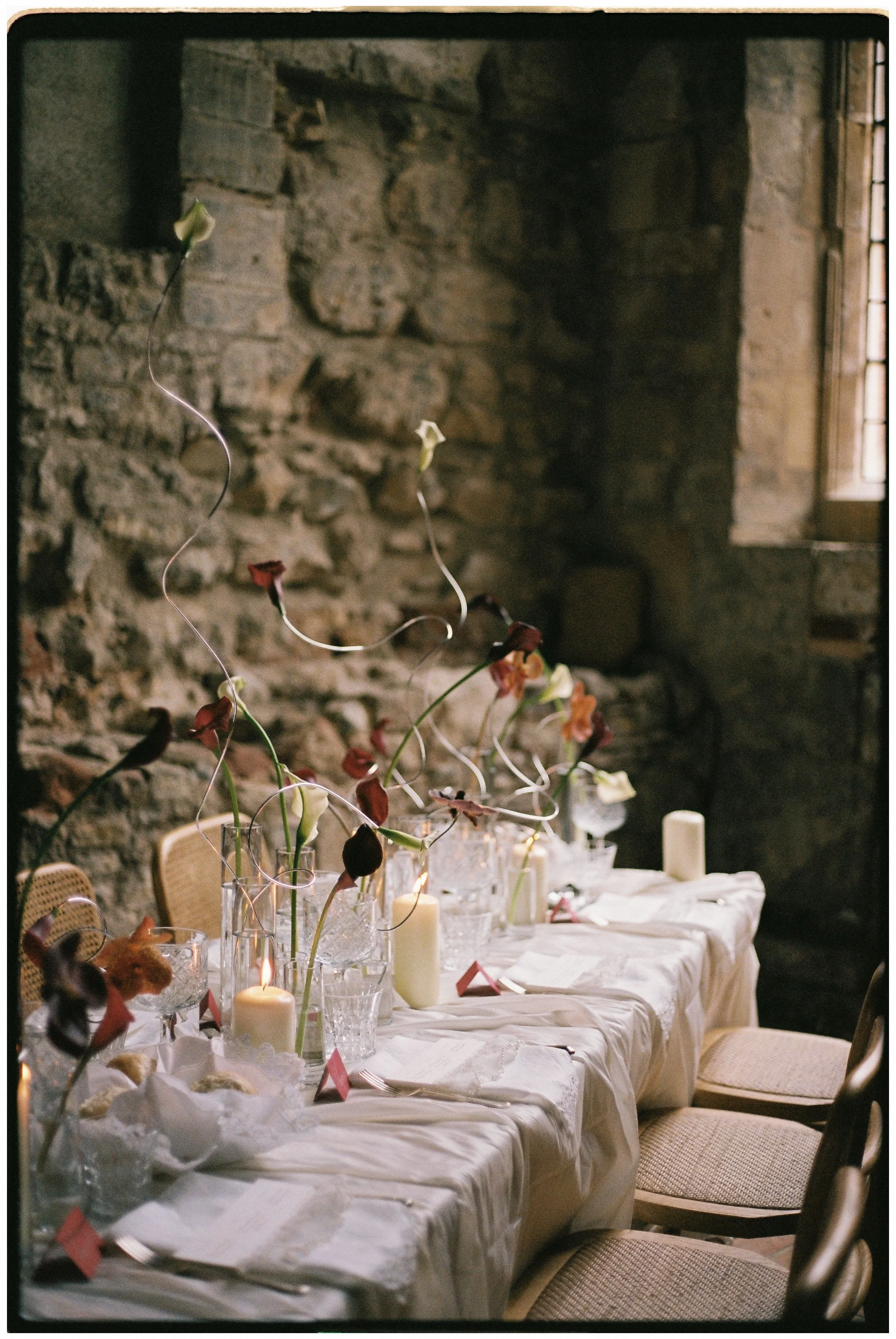 Maximalist wedding tablescape with abundant flowers, antique details and romantic Victorian styling