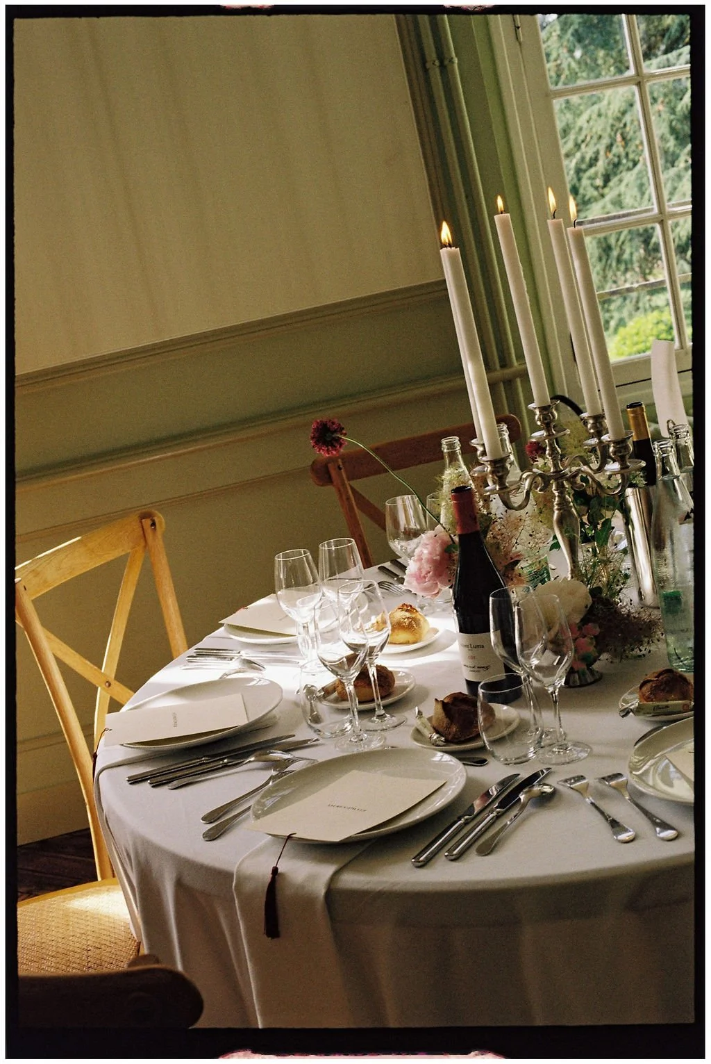 Elegant wedding tablescape with vintage silver, seasonal florals and personalised menus inside Château Laborde Saint-Martin.