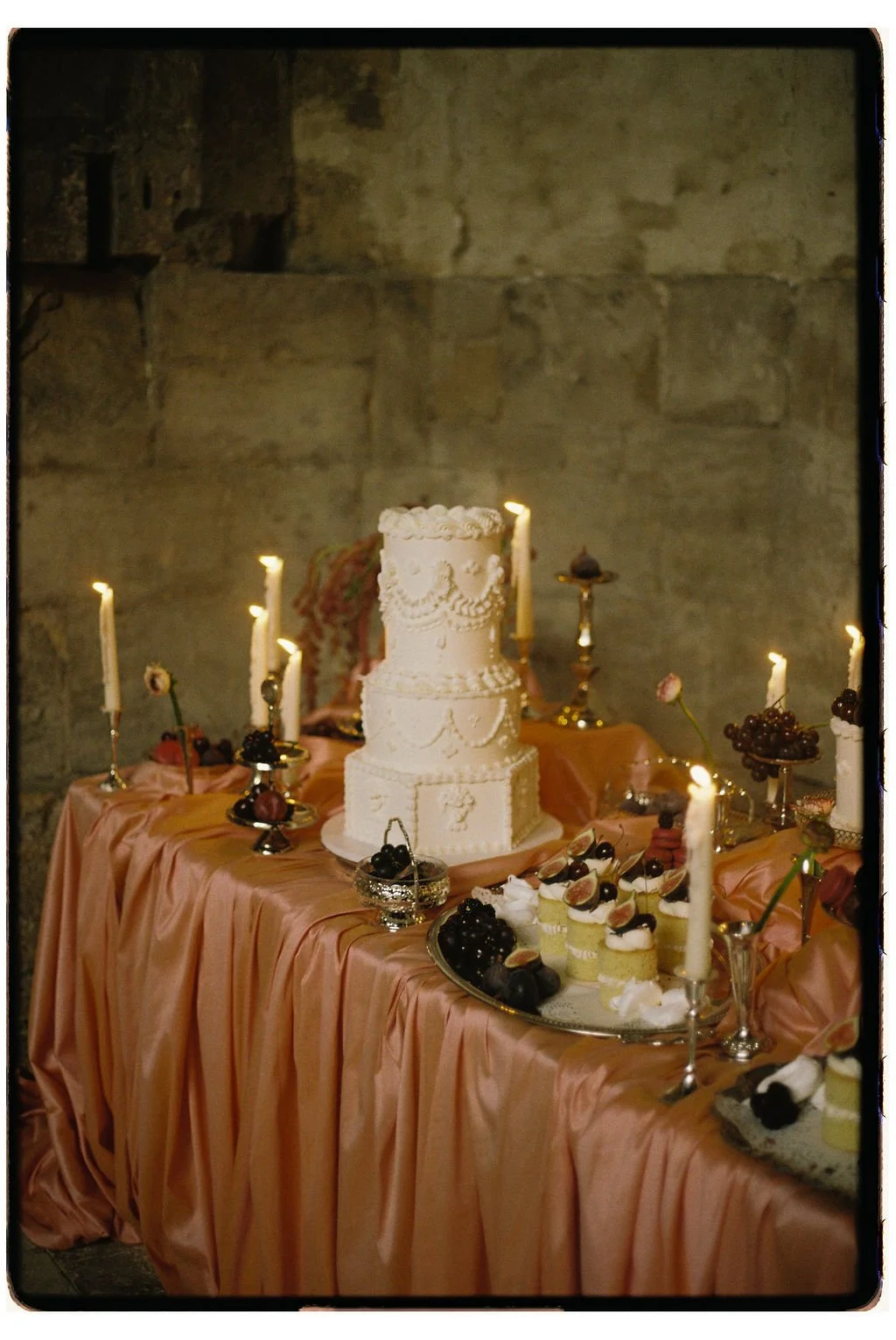 Luxury vintage wedding dessert table with soft pink tones, antique silverware and romantic styling