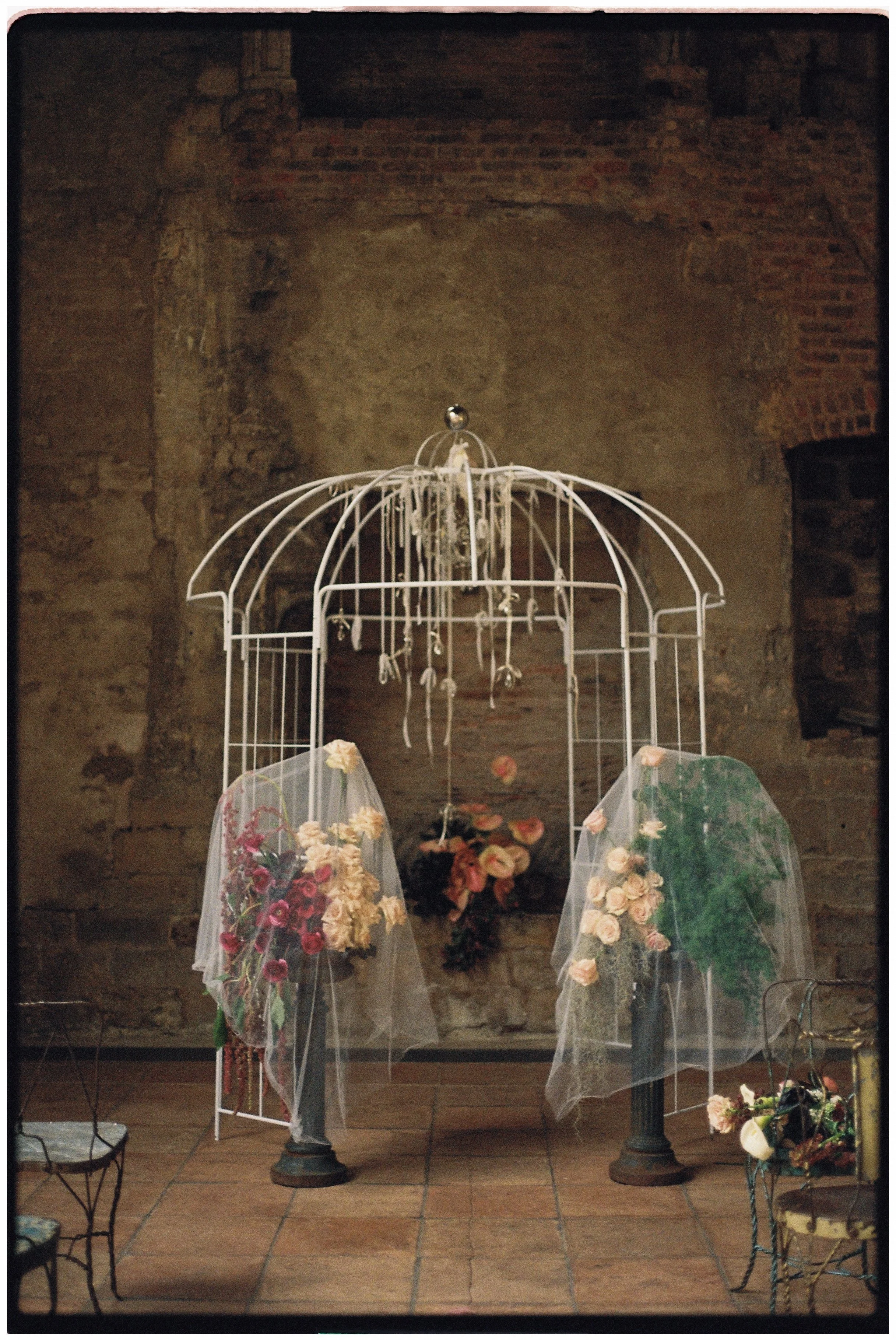 Romantic London wedding ceremony styling with flowing fabric and vintage-inspired floral details