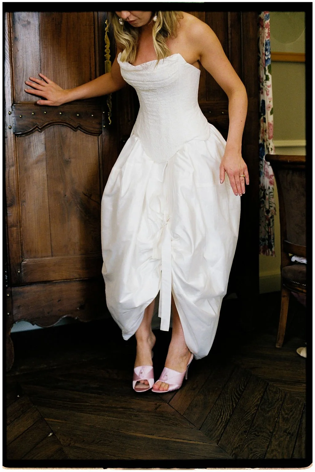 Bride wearing a timeless wedding gown with a peony bouquet by House of Prose and vintage pink Gucci heels at Château Laborde Saint-Martin, Loire Valley.