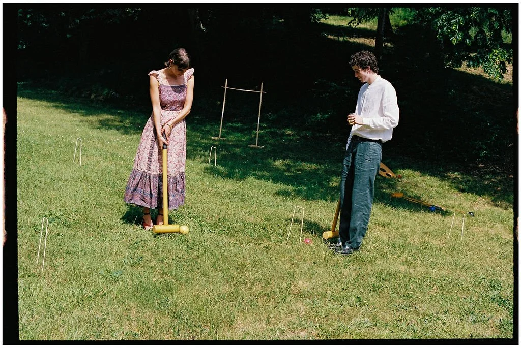Guests playing traditional lawn games during a stylish outdoor cocktail reception at a luxury Loire Valley wedding.
