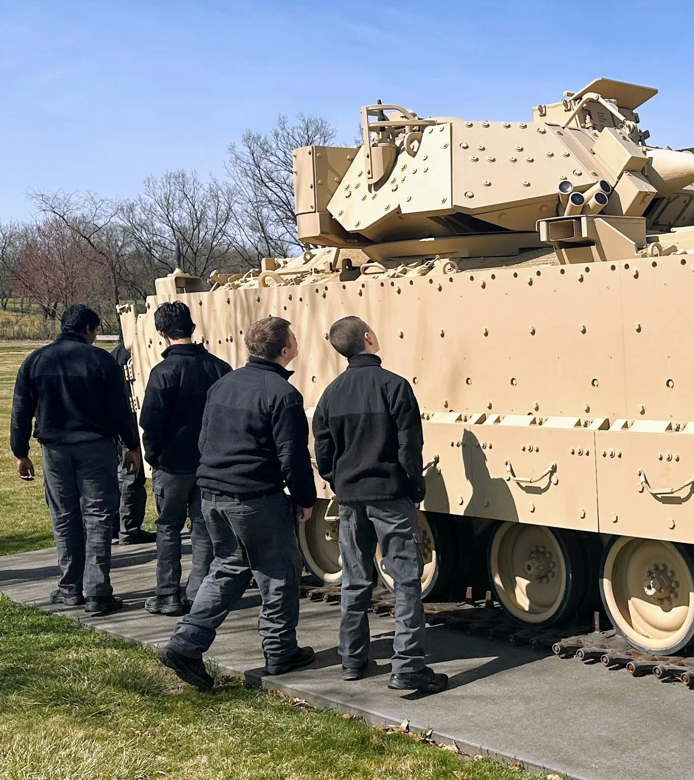 Cadets in front of a beige military tank at the Army Heritage Center in Carlisle, PA