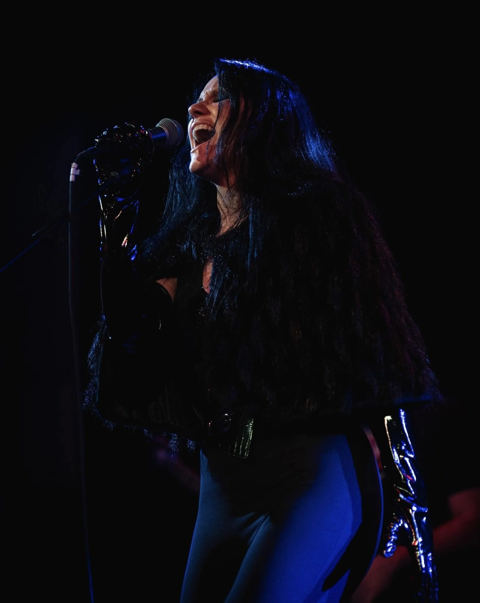 Danielle Bloom performing as an award-winning rock vocalist, singing original music inspired by resilience, hope, and becoming stronger than what tried to break you.