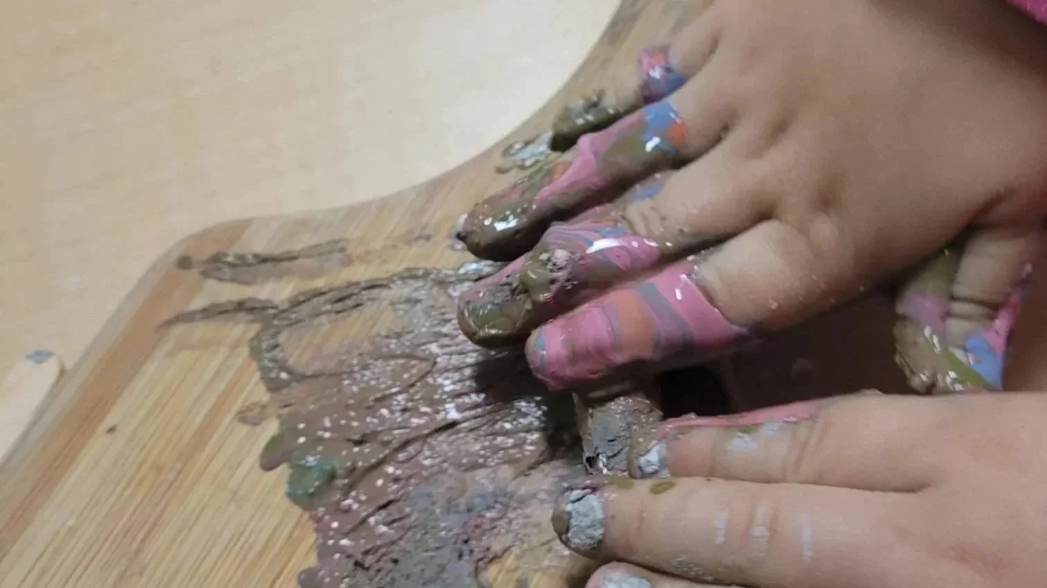 Child's hands painting.