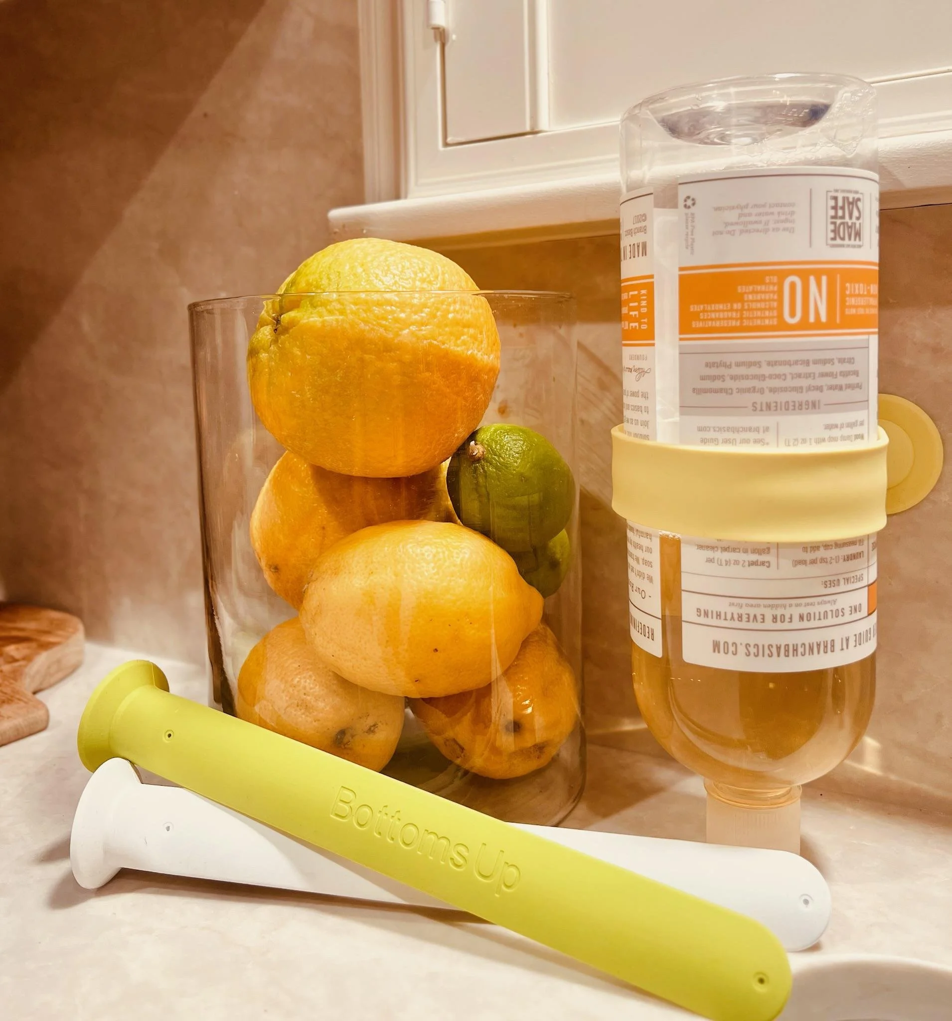 Colorful silicone bottle stabilizers with suction cups placed on a soapy surface. Bath and shower product organization. Garage organization. Kitchen organization.  Zero waste, save money. Every last drop. Lick it, Stick it and Flip it.