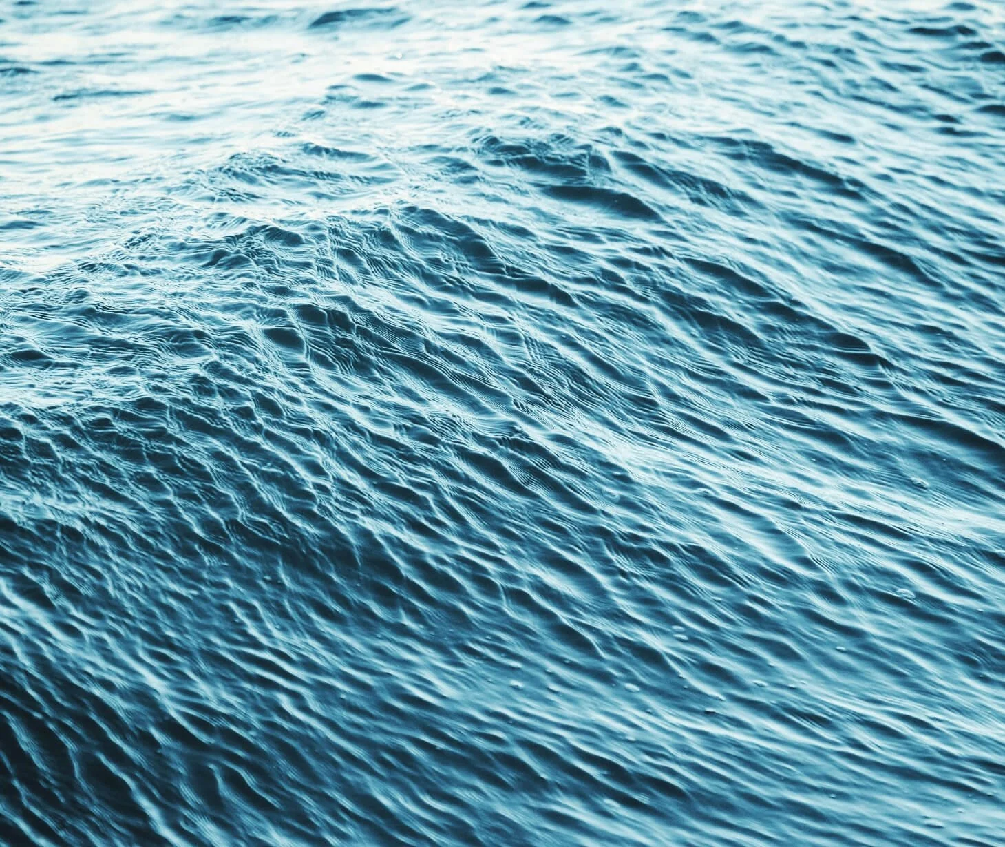 Open ocean water surface with gentle waves and ripples