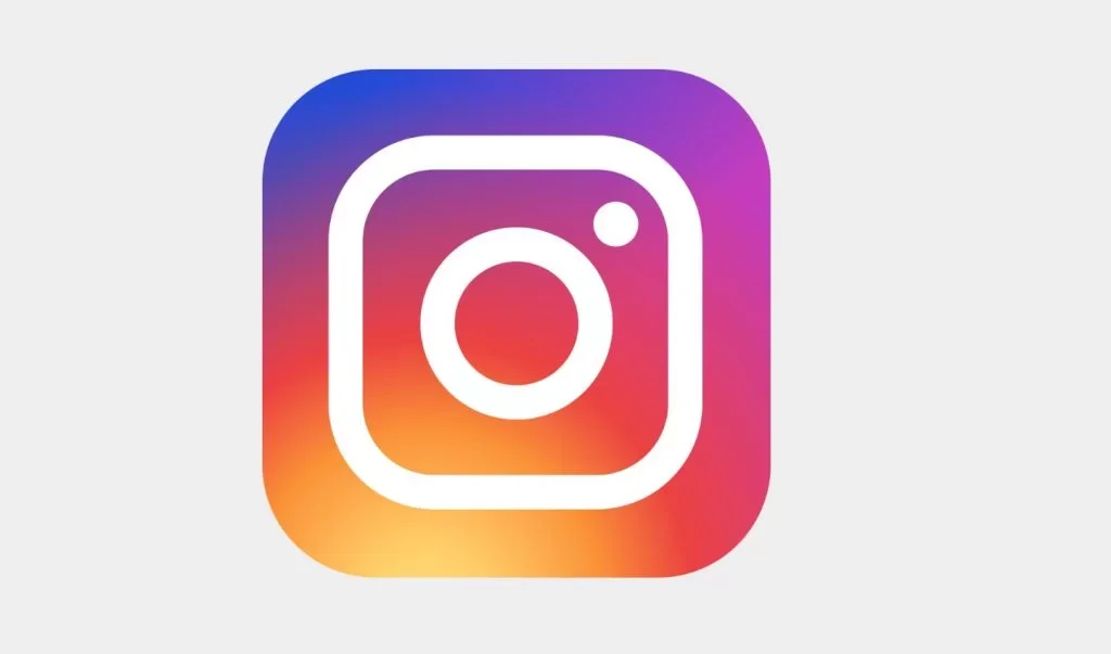 Instagram app icon with a camera outline on a multicolored gradient background.