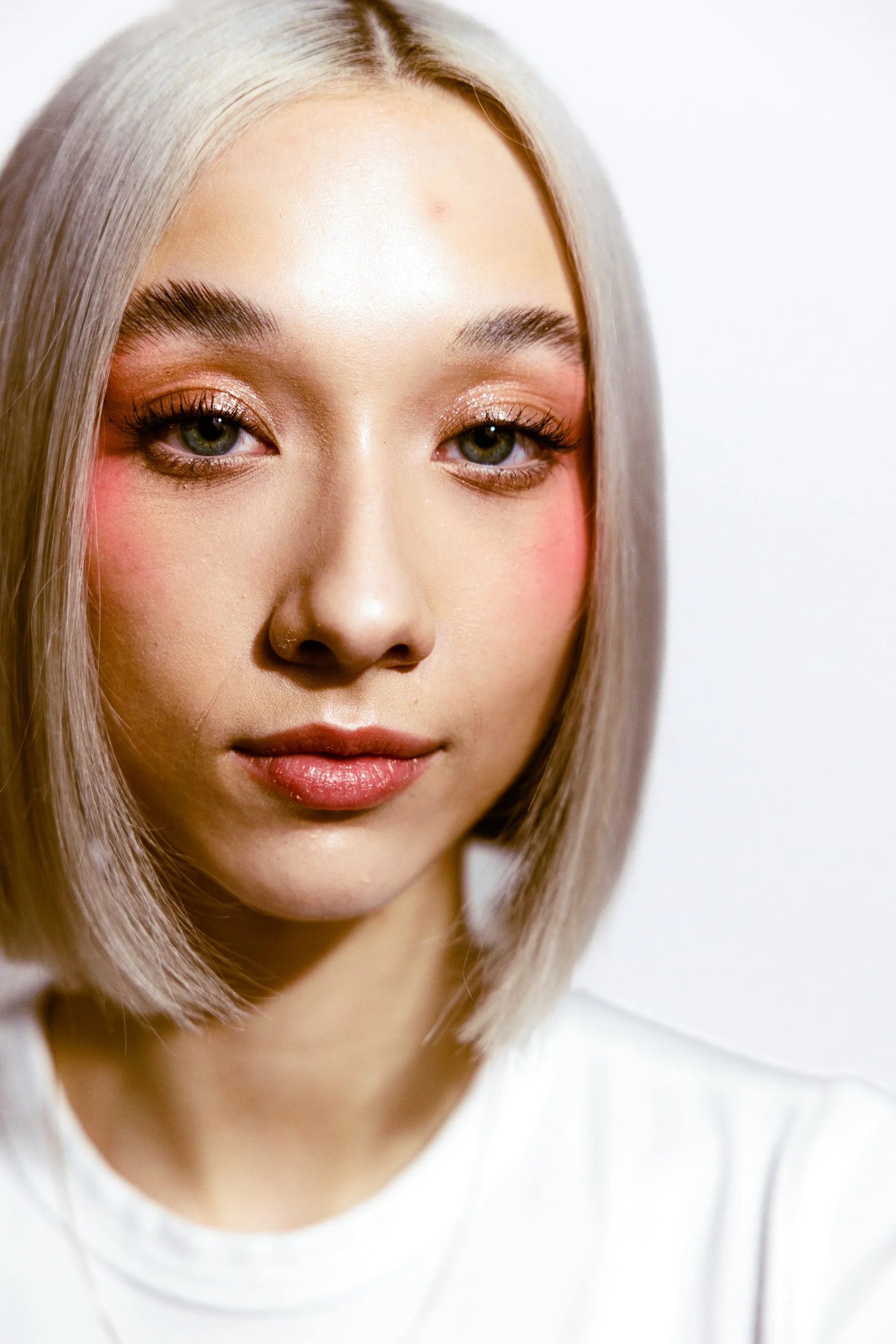 A young woman with straight platinum blonde hair at the Paloma hair salon in Jersey City.