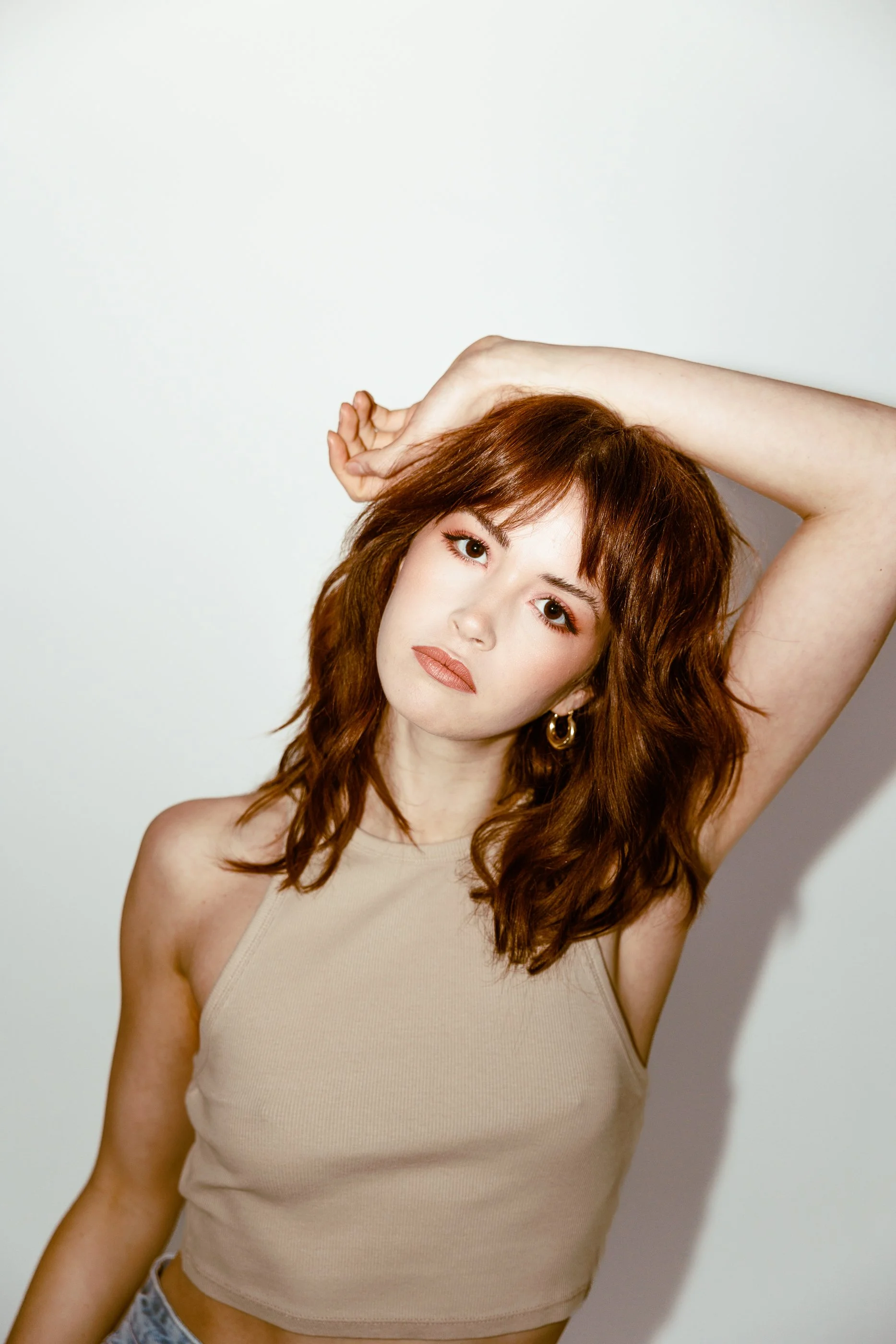 A young woman with wavy styled auburn hair at the Paloma hair salon in Jersey City.