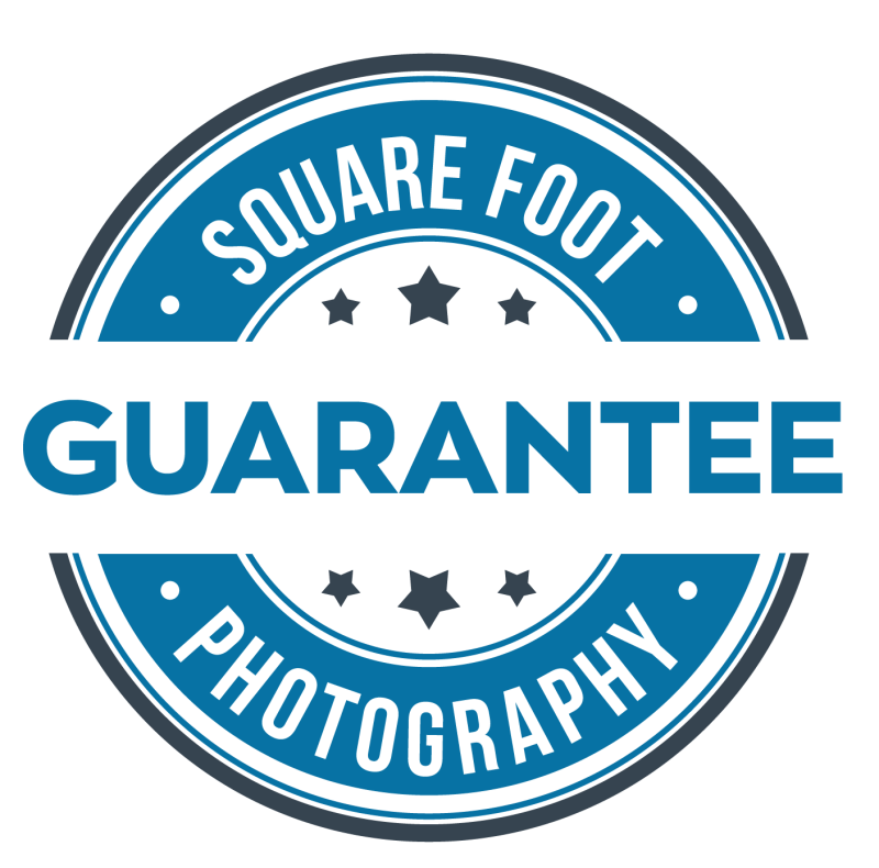 A circular badge with a blue and black color scheme. The text reads 'Square Foot Guarantee Photography,' with the word 'GUARANTEE' prominently in the center and stars surrounding it.