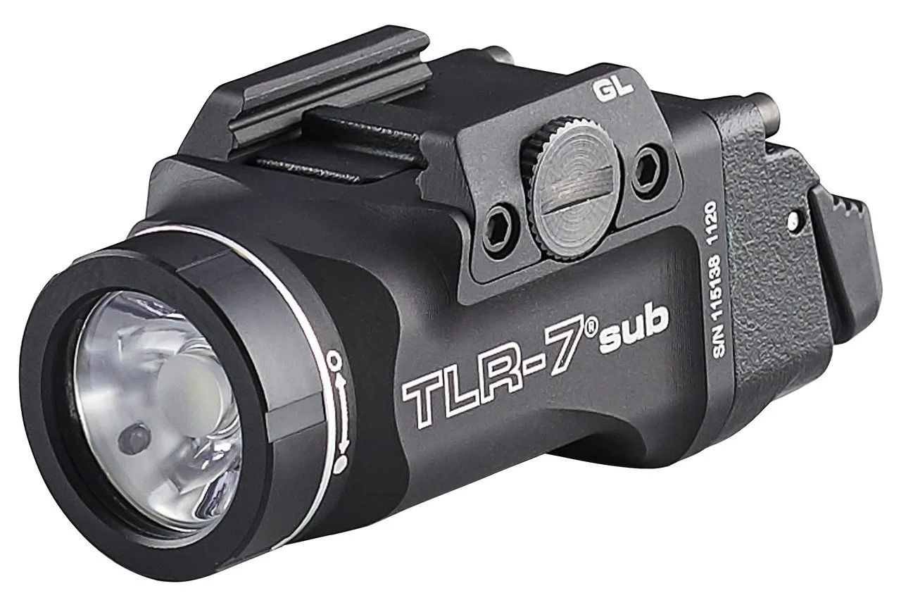 Black tactical flashlight with the label "TLR-7 sub" and a mounting bracket on top.
