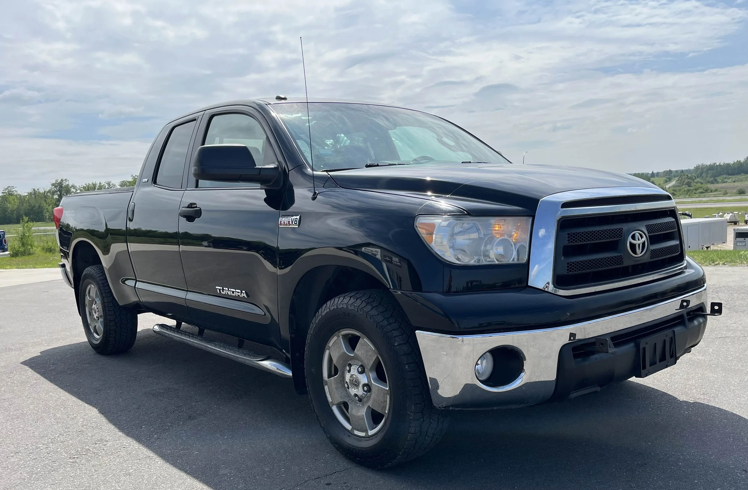 Black Toyota Tundra pickup truck parked outdoors on a cloudy day