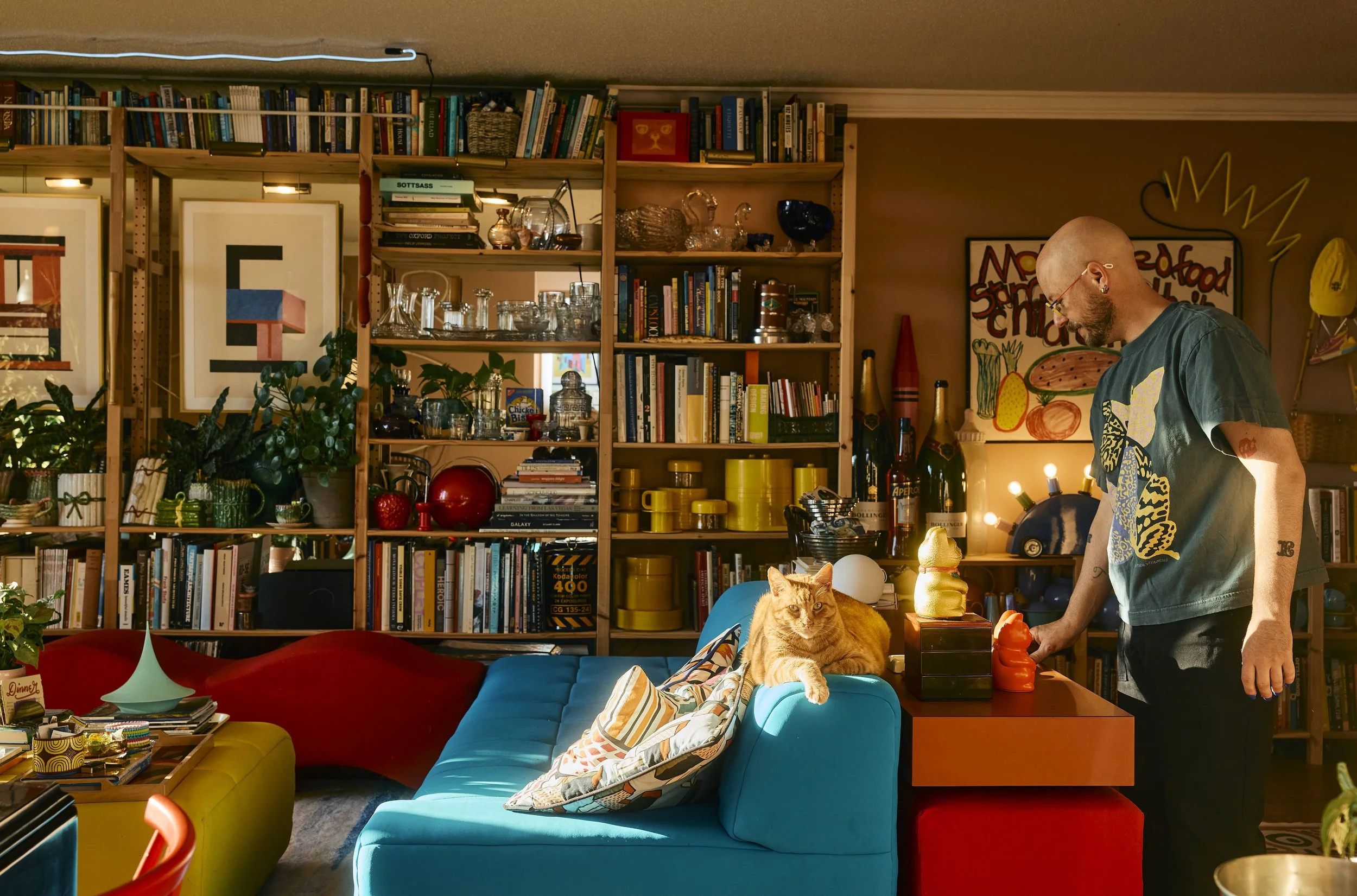 Zach and Stu the cat in their colorful Houston, TX apartment. Image by Austin-based lifestyle photographer, Mackenzie Smith.