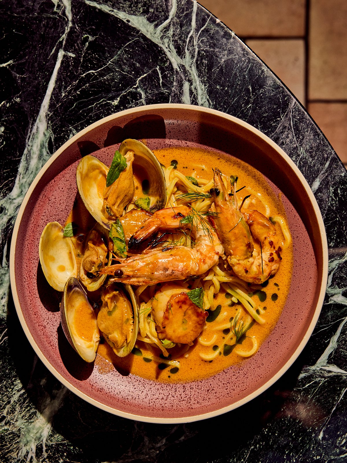 Siti's Laksa with PEI mussels, wild gulf prawns, fresh egg noodles, and coconut-galangal broth. Image by food photographer, Mackenzie Smith.