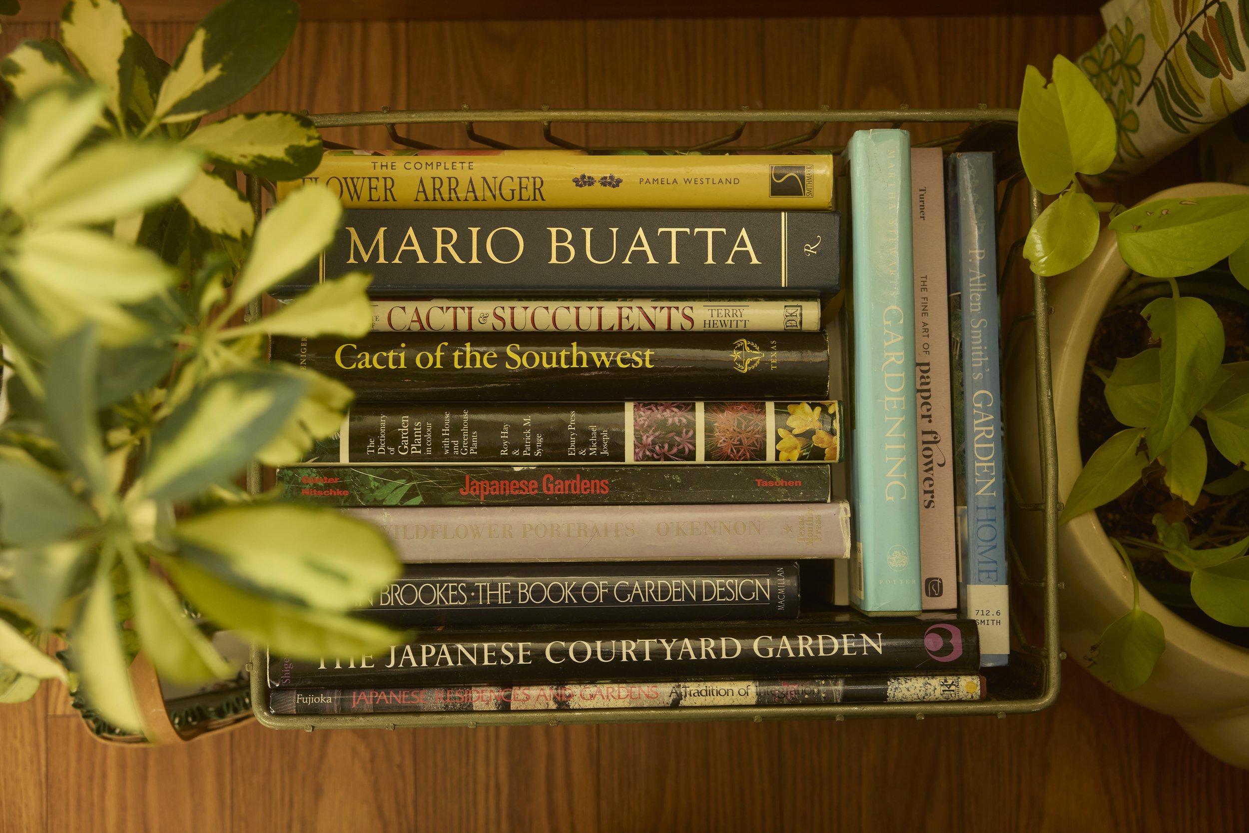 A wire crate full of books in Zach and Taylor's Houston, TX apartment. Image by Austin-based lifestyle photographer, Mackenzie Smith.