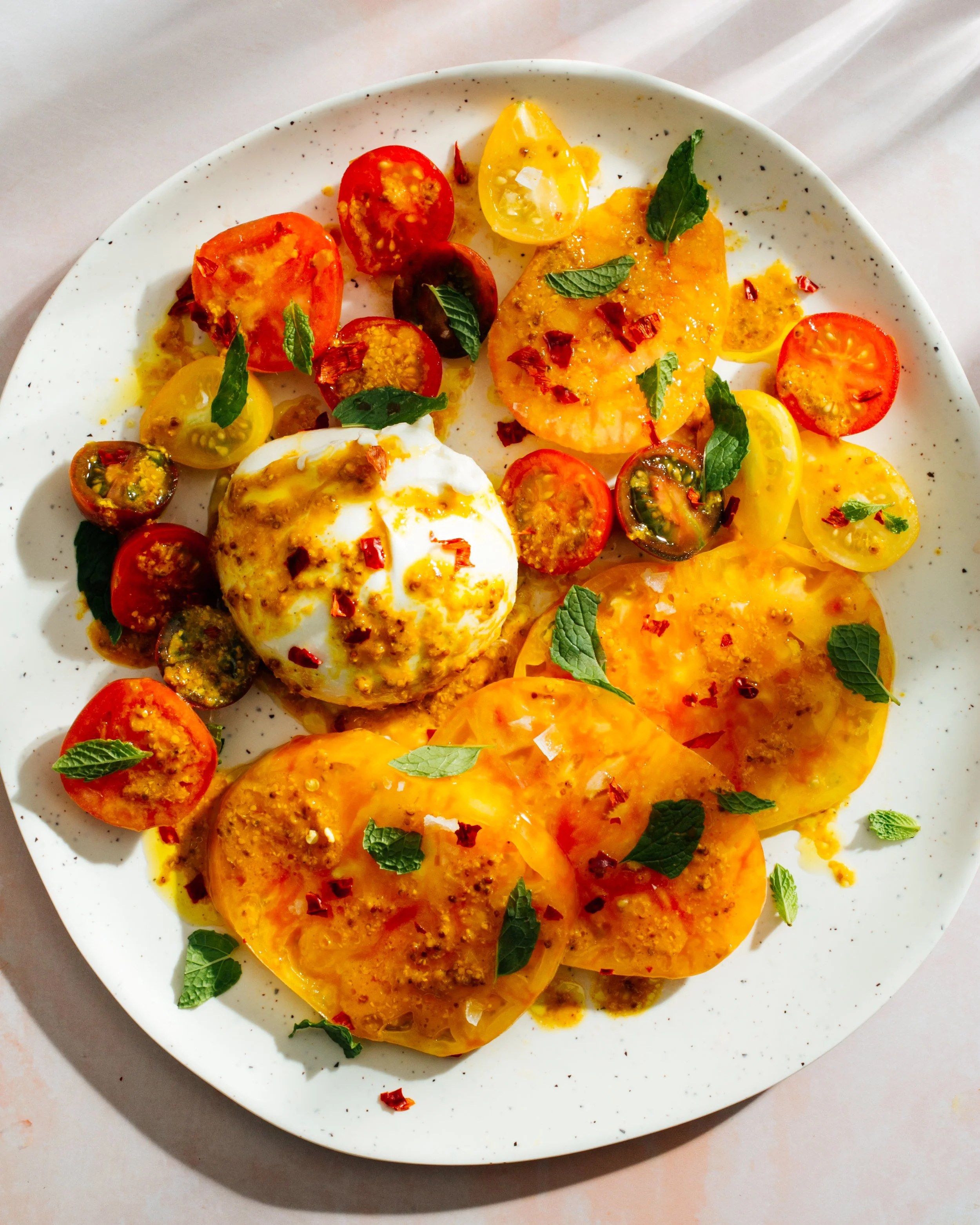 Burrata with heirloom tomatoes for Brooklyn Delhi. Food styling by Maite Aizpurua. Image by Austin-based food photographer, Mackenzie Smith.