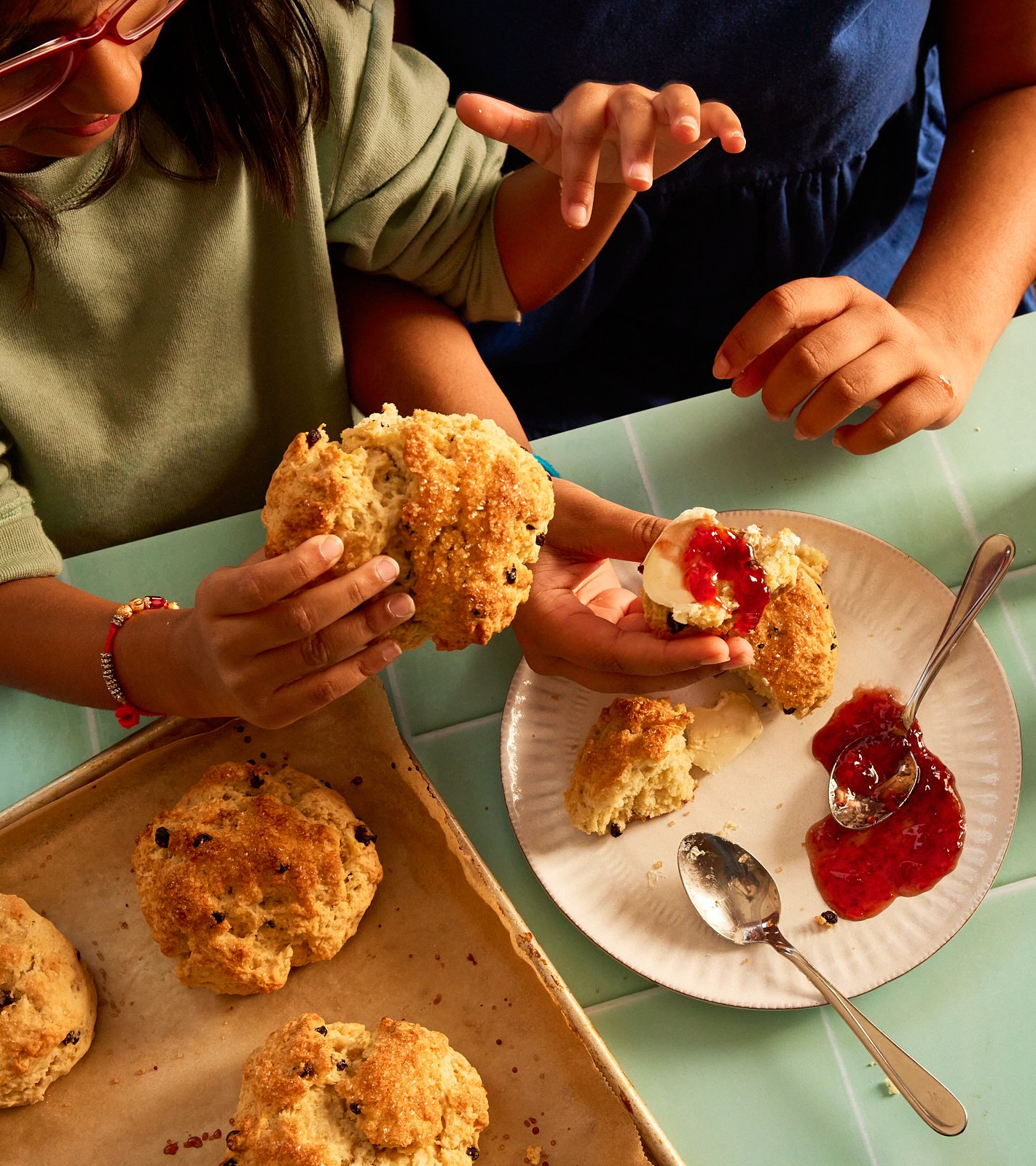 Scones with strawberry jam and clotted cream for Priya's Kitchen Adventures cookbook. Image by Austin-based food photographer, Mackenzie Smith.