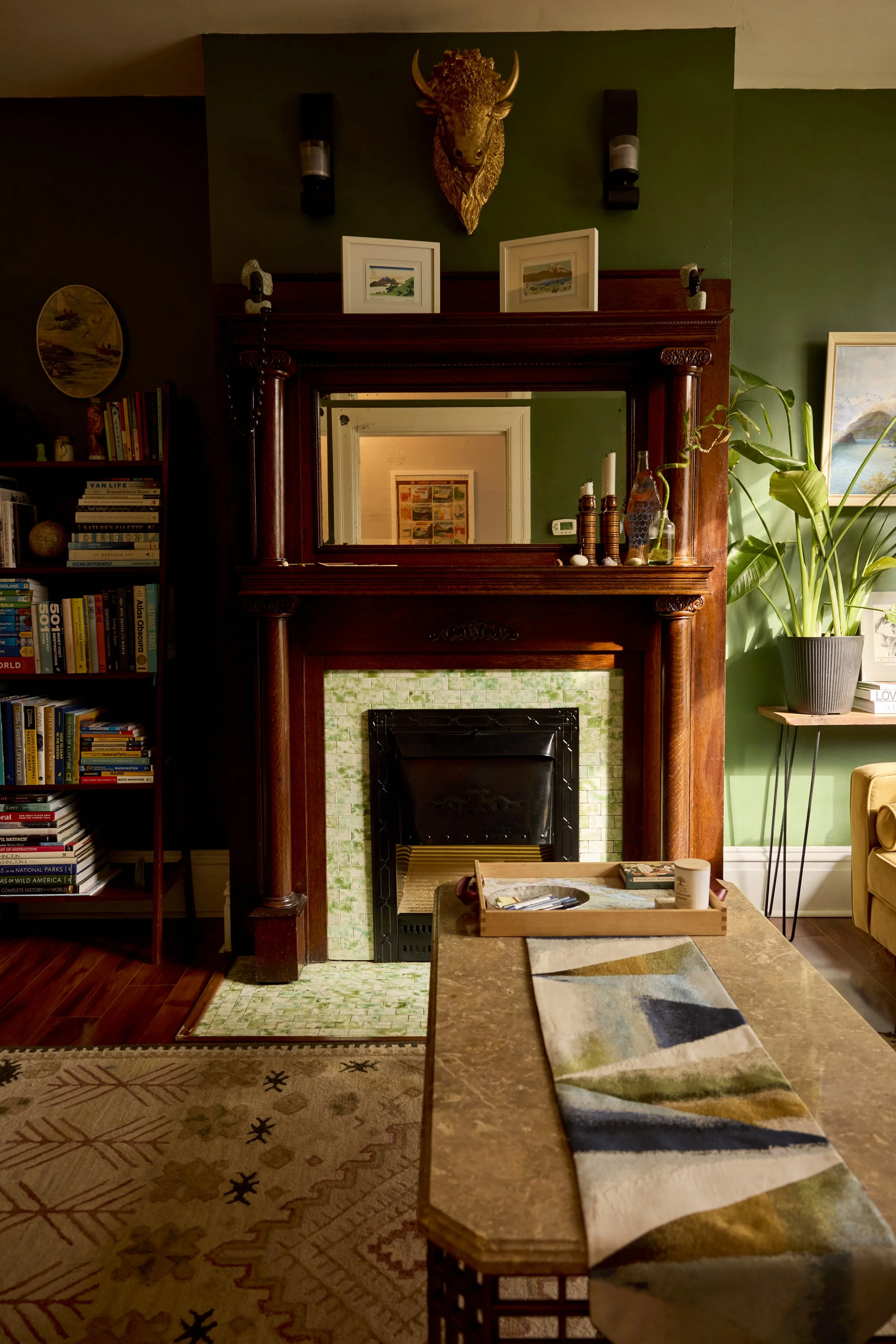 Closer look at the fireplace with a two-shelf mantle and buffalo head above. Image by Austin-based lifestyle photographer, Mackenzie Smith.